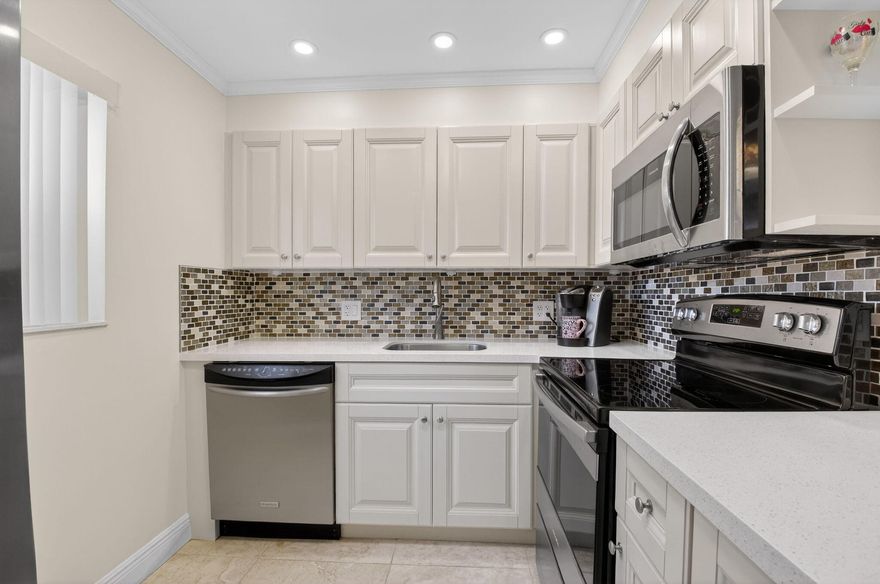 Gorgeous, fully remodeled 2BR/2BA first-floor unit in a +55 community -- a must see! No expense spared in this stunning renovation. Features include kitchen cabinetry with quartz countertops, fully renovated baths, in-unit washer & dryer, updated electric and breaker panel, porcelain flooring, upgraded lighting and fixtures, window treatments, and crown molding with accent lighting. Ideally located near the Flanders clubhouse in Kings Point Golf and Country Club, offering resort-style amenities including pickleball, indoor & outdoor pools, fitness center, theater, tennis, courtesy bus service, and countless clubs and activities.