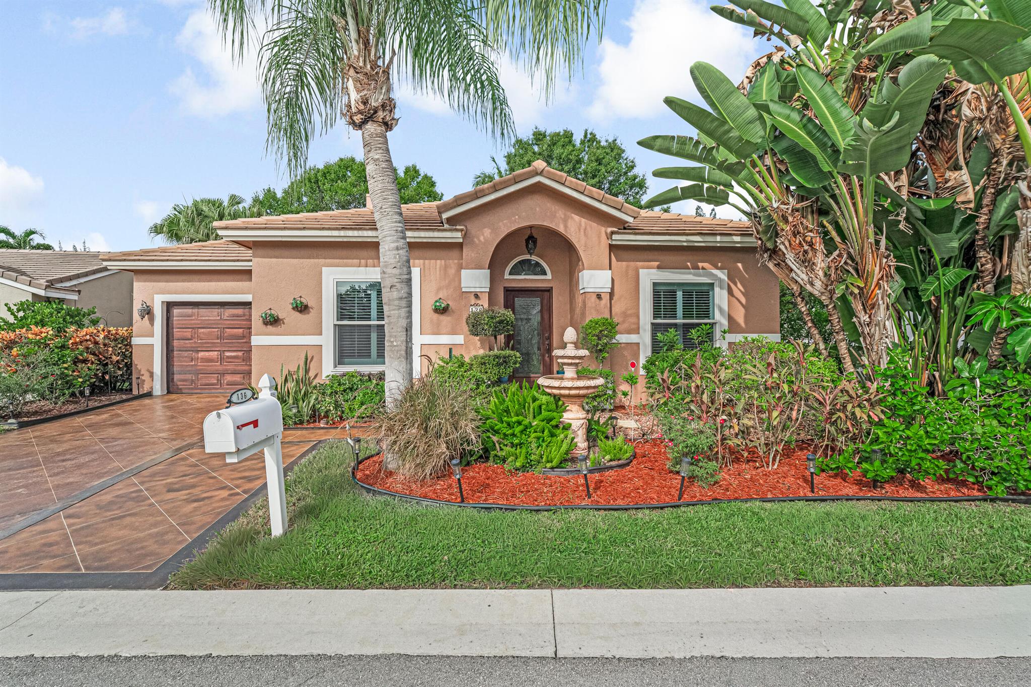 Nothing to do but bring your toothbrush!This completely updated home is move-in ready and perfectly located in the heart of Palm Beach County. Featuring Pella CAT5 impact windows, four sets of 8' hurricane-rated sliding glass doors, an impact-insulated garage door, and a 2018 barrel tile roof, this property is built for comfort and peace of mind.Inside, you'll find a modern kitchen with soft-close drawers, cabinets, and dual lazy Susans, plus a cozy living room with fireplace and gorgeous water views. The master suite is fully customized with a beautifully upgraded bathroom and spacious walk-in closet. A second bedroom also functions as a master with en-suite bath and private separation from the living area.