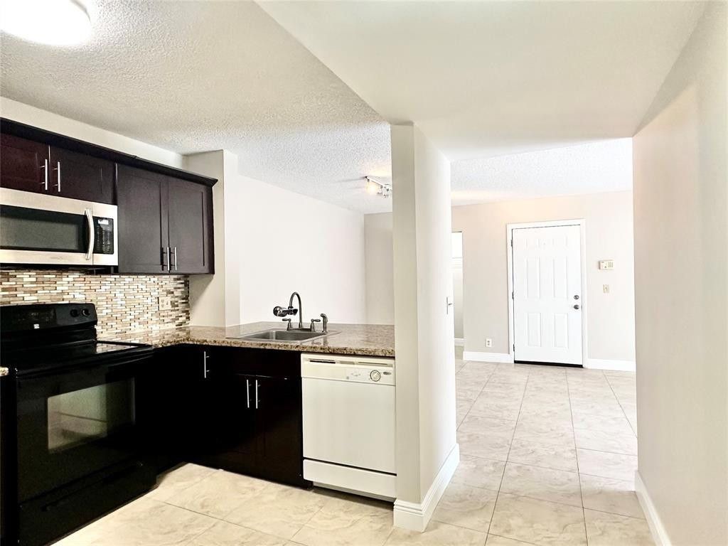 Photo of 10741 Cleary Boulevard #102, Plantation, FL 33324 (MLS # F10543011)