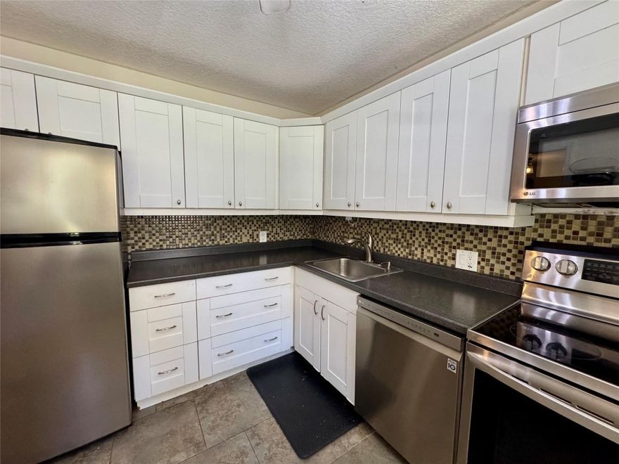 Welcome to this spacious one bedroom residence overlooking the lush fairways of Palm Aire. Filled with natural light this home offers an open and airy layout ideal for comfortable living and entertaining. Enjoy serene golf course views from the balcony and bedroom creating a peaceful background all year long. The dishwasher, oven/store, microwave oven and hot water tank have been replaced in 2022. Parking spot #26.