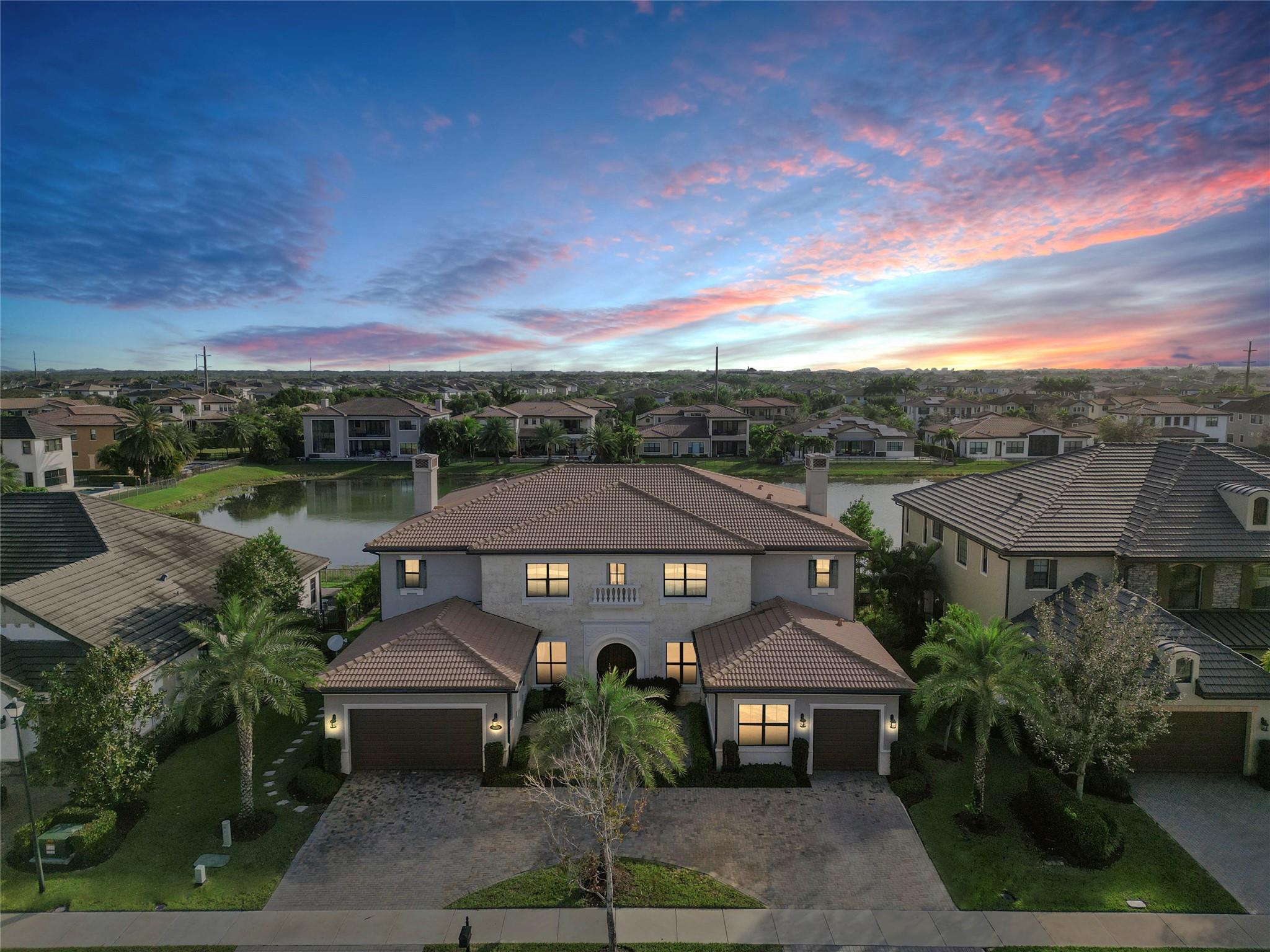 This magnificent Wentworth model is located on a tranquil water lot in Parkland's most sought after community! Features beautiful finishes, a grand foyer entrance with dramatic dual spiral staircases, formal living and dining rooms, casual dining, family room, club room, playroom, 2 primary suites & den. The chef's kitchen has a huge center island, granite counters, a walk-in pantry, Wolf SS appliances & a Butler's pantry! Other features include wood tile plank flooring in the main living areas, French doors, tray ceilings & crown molding. Enjoy entertaining friends and family on the oversized travertine patio with the pergola & outdoor kitchen! Watercrest has amazing amenities, a 24 hour gated entrance, low HOA fees & great area schools! The best of South Florida living!