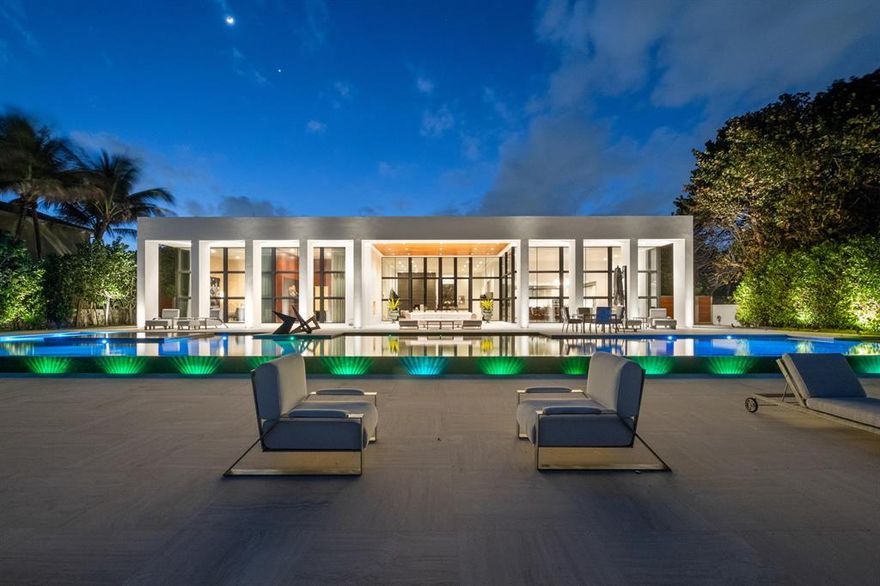 One of the finest 'Museum Modern' contemporary Ocean to Intracoastal estate homes in Florida.  With 125 feet of beachfront on the Hillsboro Mile, this one-of-a-kind residence was created to capture stunning sunrise and daytime views of the ocean and the 90 foot infinity edge pool and spa, thru floor-to-ceiling glass windows and 15 foot ceilings.  Located in the ultra safe and secure town of Hillsboro Beach, a private gate open to an elevated stone driveway that leads to a home and site that stretches 385 feet to the ocean. An open glass modern Intracoastal two story/two suite guest house captures 'no wake' yacht travel and magnificent sunsets with its own kitchen, pool, entertainment area and two car garage.  Simply put, a most captivating, inspiring and ultra luxurious estate. See More...