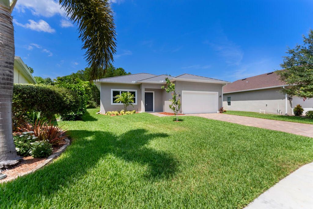 Photo of 675 NE Moss Rose Place, Port Saint Lucie, FL 34983 (MLS # R11092888)