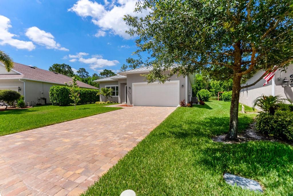 Photo of 675 NE Moss Rose Place, Port Saint Lucie, FL 34983 (MLS # R11092888)