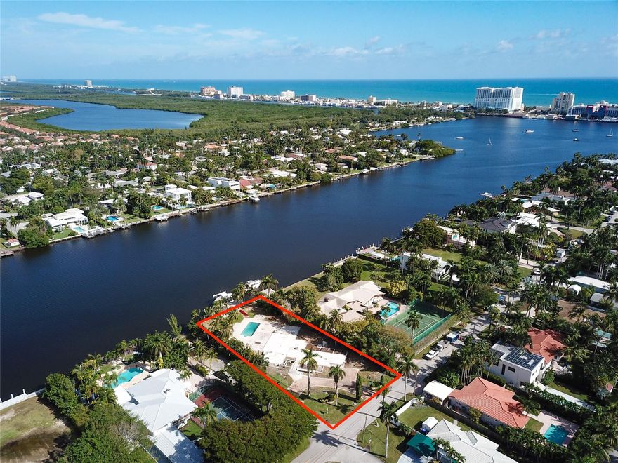 Discover the perfect canvas for your water front dreams. This buildable lot with plans included boasts 100 ft of intracoastal frontage, a refreshing breeze, and panoramic views. The new seawall exceeds NAVD88 requirements, ensuring durability and resilience.  The brand-new state of the art dock is complete with a new 33,000lbs boat lift  as well as jet ski lift and offers seamless access to the ocean. Here you will also find modern convenience with digital controls for Wi-Fi and lights, allowing you to customize your waterfront experience. Enhance your evenings with enchanting underwater lights. With electricity and water already extended to the dock, imagine the ease of coastal living. This corner lot, spanning 233 ft deep provides a unique opportunity to craft your coastal masterpiece.