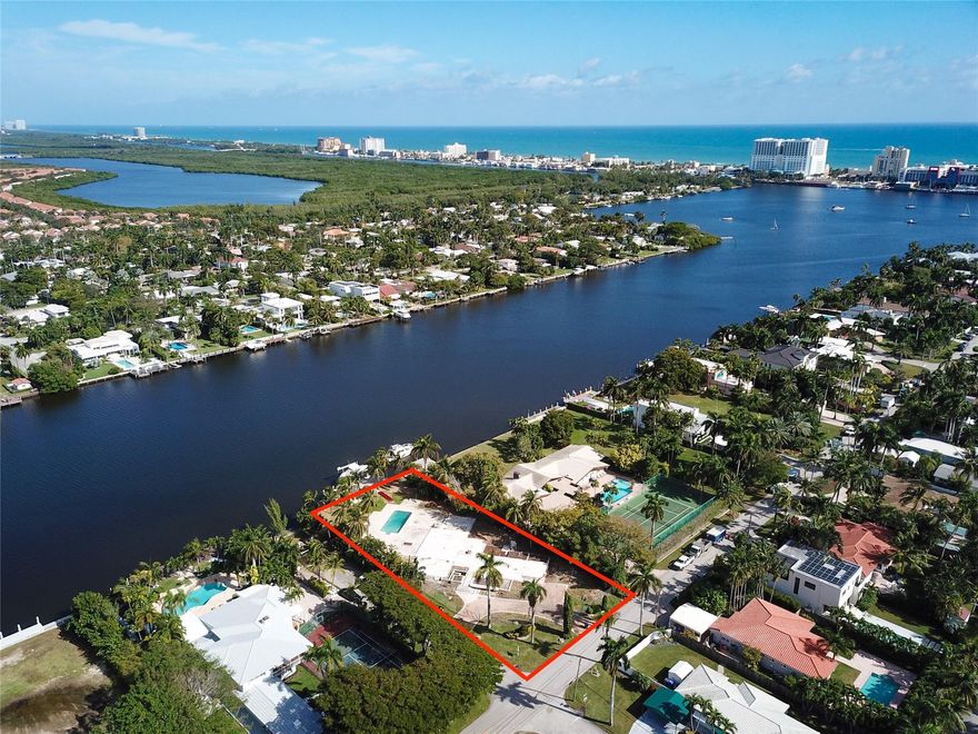 Discover the perfect canvas for your water front dreams. This buildable lot with plans included boasts 100 ft of intracoastal frontage, a refreshing breeze, and panoramic views. The new seawall exceeds NAVD88 requirements, ensuring durability and resilience.  The brand-new state of the art dock is complete with a new 33,000lbs boat lift  as well as jet ski lift and offers seamless access to the ocean. Here you will also find modern convenience with digital controls for Wi-Fi and lights, allowing you to customize your waterfront experience. Enhance your evenings with enchanting underwater lights. With electricity and water already extended to the dock, imagine the ease of coastal living. This corner lot, spanning 233 ft deep provides a unique opportunity to craft your coastal masterpiece.