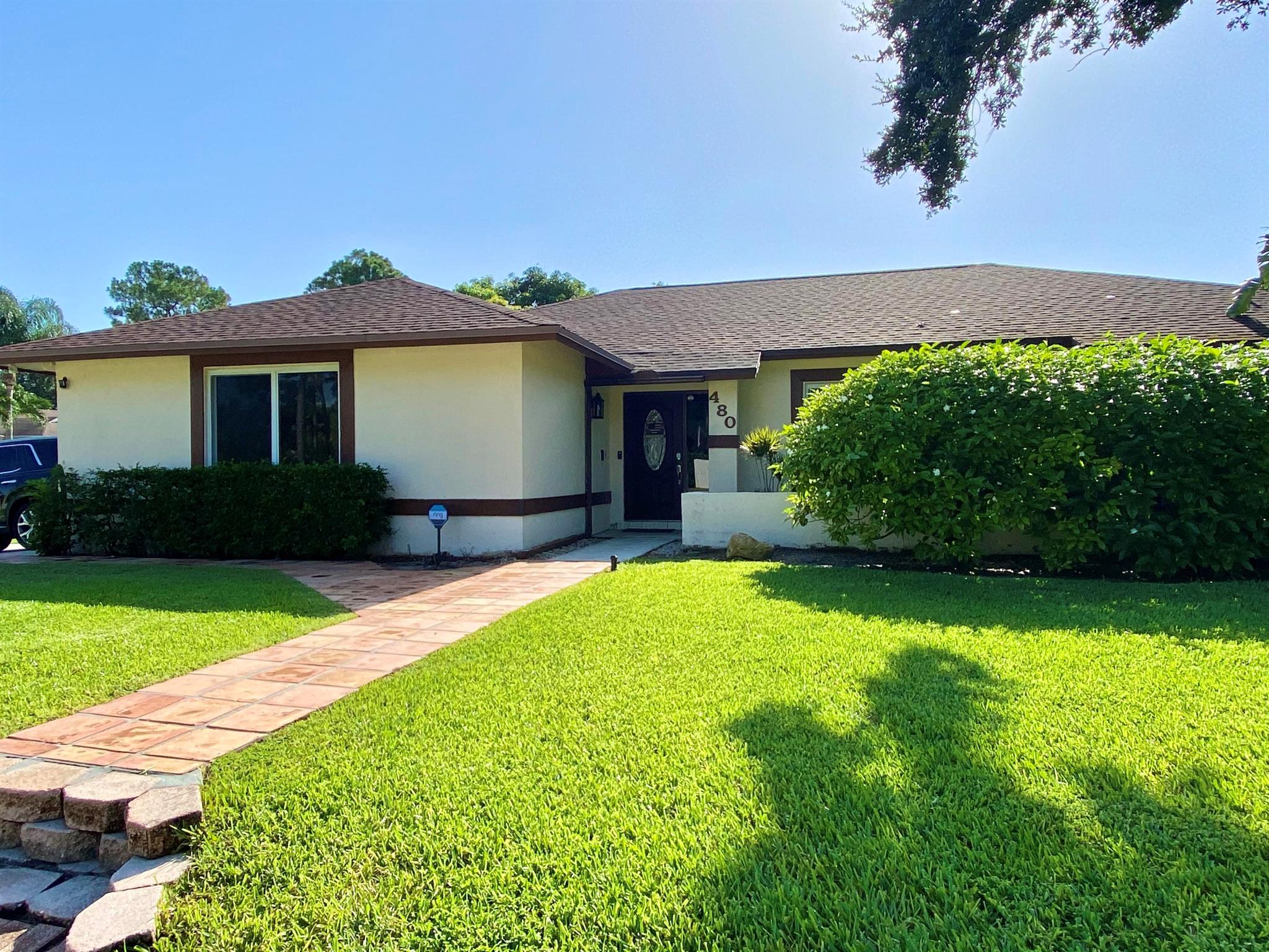 Welcome home to this spacious 3 bedroom, 2 bathroom pool home in the heart of Wellington's Sugar Pond neighborhood! This beautifully updated home features a split floor plan with vaulted ceilings, wood and tile flooring throughout (no carpet), and hurricane impact windows for peace of mind. The primary suite offers a spa-like retreat with a large walk-in-shower, dual vanities, and plenty of closet space. The modern kitchen and bathrooms have been tastefully remodeled with stylish finishes. Step outside to your own backyard oasis-a large fenced-in yard, screened patio, and private pool perfect for relaxing or entertaining. Located on a corn lot within walking distance to schools, and minutes to shopping, dining, equestrian venues, and community parks.