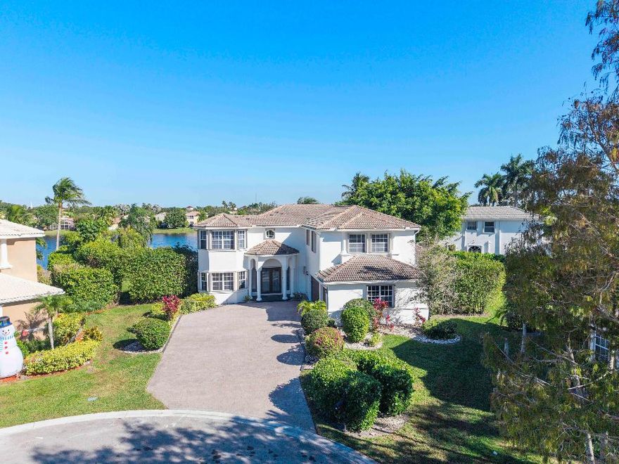 Resort lifestyle!

This colossal 7-BR waterfront estate is the largest in the community, set on a rare .38-acre cul-de-sac lot.

Enjoy total privacy with panoramic lake views.

Soaring 20' ceilings.

Concrete 2nd-floor construction. 

The massive primary suite offers a private sitting area and spa-like bath.

Outside, an entertainer's paradise features a 27' covered lanai, outdoor kitchen, and heated pool, surrounded by lush tropical landscaping. 

Side-entry 3-car garage with parking for 8. 

First floor 20x20 wing functions as an office / 7th bedroom or rec room. 

Premier guard-gated community zoned for Marjory Stoneman Douglas. HOA includes 24/7 monitored life-safety/intrusion security. Move-in ready!