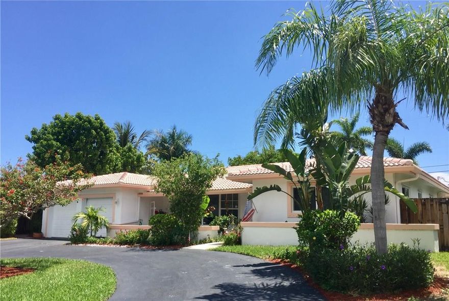 Great home in the heart of Lighthouse Point, Large 4 bedroom home with 3 full baths.. Triple split floor plan with extra room off master bedroom which would be great for an office/den or make it a dream closet!  Nice size updated kitchen with Granite and SS appliances opens to family room..  Hurricane Impact doors and windows (French doors have accordion shutters), Full two car garage with two newer reinforced impact doors,  Fenced yard with lovely freeform pool !This home is priced to SELL!
