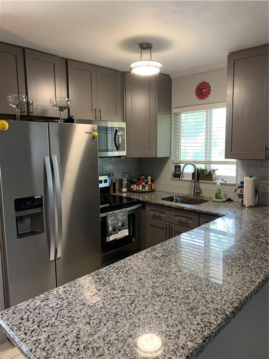 Amazing opportunity awaits in Wilton Manors! You will fall in love with this second floor corner unit at Windsor Court! This gem offers a stunning, redesigned kitchen with granite and SS appliances including dishwasher and is open to the dining area and bright living area.  Master is a good size and offers a walk in closet and the second bedroom also offers a large closet and your own washer/dryer. Adorable updated bath and AC and water heater are less than 4 years old. Tile flooring throughout along with decorative accents make this one feel like "home"! Exterior offers loads of parking and a relaxing pool area. Pets allowed and OK to rent after 1 year.  Excellent location seconds to Wilton night life and major roadways and shopping.  Just a few minutes to downtown and the beach!