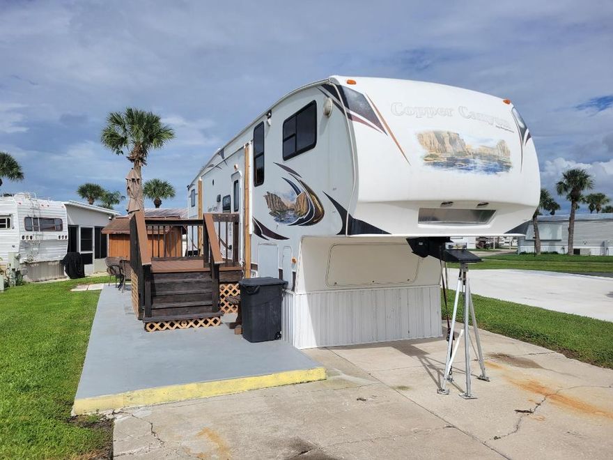 Presenting a well-maintained fifth-wheel residence within the desirable, 55+ Ancient Oaks RV Resort. This affordable option offers a low-maintenance lifestyle, featuring recent upgrades including a new A/C system and updated roof, complemented by an outdoor kitchen area. The community provides extensive amenities such as a clubhouse, pickleball courts, dedicated dog walks, and water access with a ramp and docks. Inquire today to schedule a private viewing.