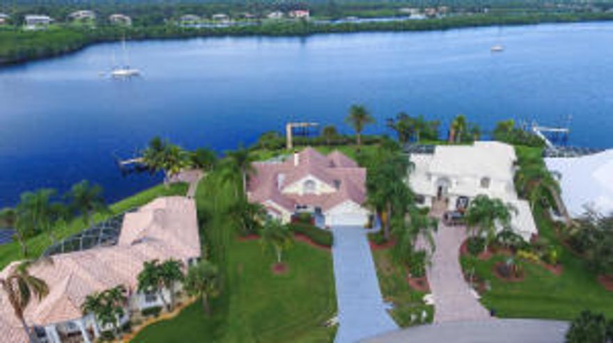 Gorgeous home on the wide water of the St. Lucie River! This 3 bedroom, 2 full bath, PLUS den/office, PLUS a loft; boasts high vaulted ceiling with tons of natural light! Kitchen was recently remodeled with granite counter tops and all stainless steel appliances. This home features other upgrades such as plantation shutters, new tile floors throughout main living area, & new laminate wood floors in the Master bedroom. Watch the gorgeous south Florida sunset from your dock! This is a boaters paradise!