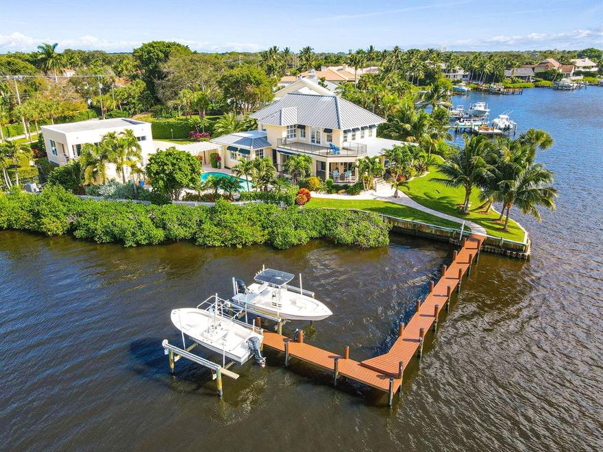 Rare opportunity to own a one of a kind property on 390' of waterfront situated on a private point on the NE Loxahatchee River. Built in 1926, this Key West inspired home was one of the first plantations (fern) to be built in the area.  This amazing riverfront home has 5 BR, 3 BA and was newly re-designed so that every room has spectacular views of the water.  Features of this home include all impact doors/windows, generator, auto-screened in porch, custom kitchen with gorgeous wood counter tops, 2 boat lifts on the newly reconstructed dock. The 1 BR/1 BA Guest House just completed in December 2020 has that simple, timeless coastal look  (+full kitchen) that no guest will want to leave. Minutes to the Intracoastal and Jupiter Inlet, this property offers the ultimate in a Florida lifestyle! Sit back and relax on the wrap around veranda which offers 180 degree views and breathtaking sunsets overlooking the Loxahatchee River. Renovated in recent years, this property still maintains the opulence and charm of days past in Tequesta with added styles of unsurpassed craftsmanship and functionality of today's standards.