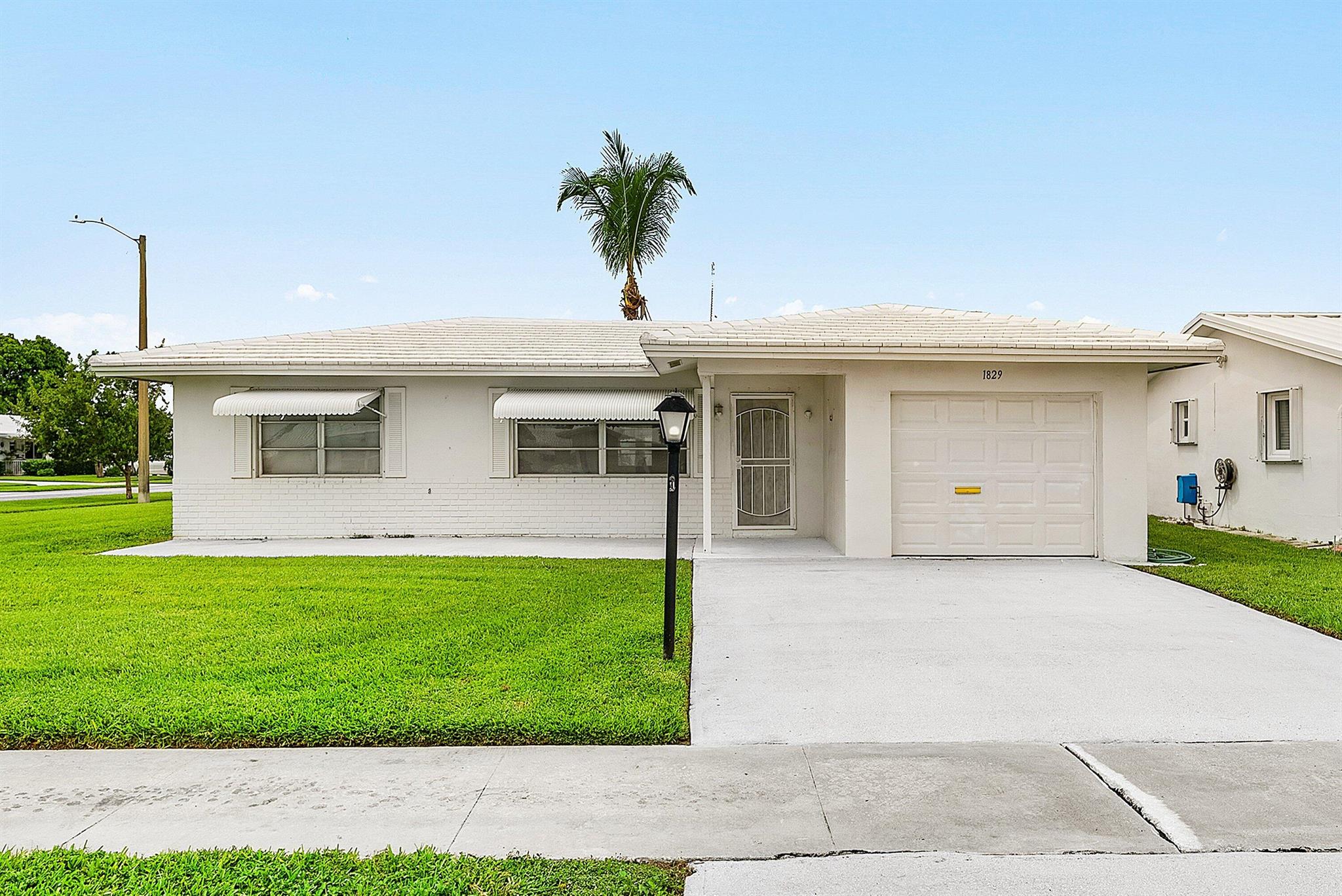 Welcome to this charming 2-bed, 2-bath single-family home on a desirable corner lot in Palm Beach Leisureville, a vibrant 55+ community. This inviting residence is a blank canvas, offering a perfect opportunity to customize every detail to your taste.You're just a short stroll from the community pool and fitness center at Clubhouse 2. Enjoy an exceptional lifestyle with an incredibly low monthly HOA fee that includes free golf on the private 18-hole Par 3 course, access to three clubhouses with their own pools, and a calendar full of social clubs and activities.Conveniently located just minutes from I-95, major shopping, and dining, this home perfectly balances relaxation and accessibility. Embrace the ultimate Florida lifestyle!