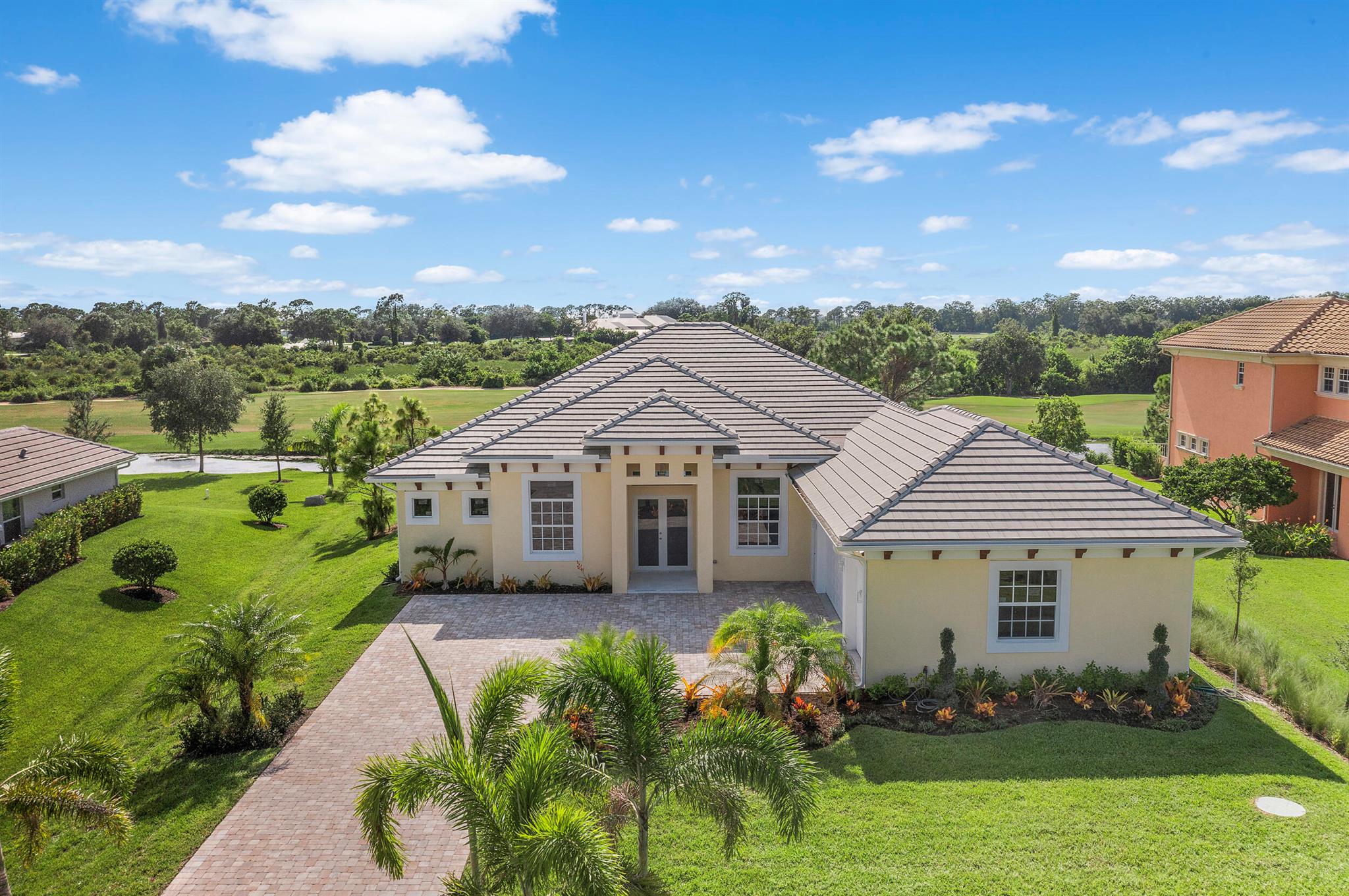 Brand-new modern estate in Palm City's prestigious Cobblestone community, overlooking the recently renovated Cape Club golf course. This home sits on a half-acre lot with low HOA fees and was designed for both elegance and comfort. Featuring soaring 10-14 ft. ceilings, crown molding, upgraded tile throughout, and a bright open-concept layout. The chef's kitchen boasts a large island and premium appliances, while the split plan includes a private guest suite off the pool. Enjoy the ultimate Florida lifestyle with a spacious outdoor living area, summer kitchen, and resort-style pool with raised spa, all capturing panoramic golf course views. Don't miss this rare opportunity to own New Construction in a gated golf course community!