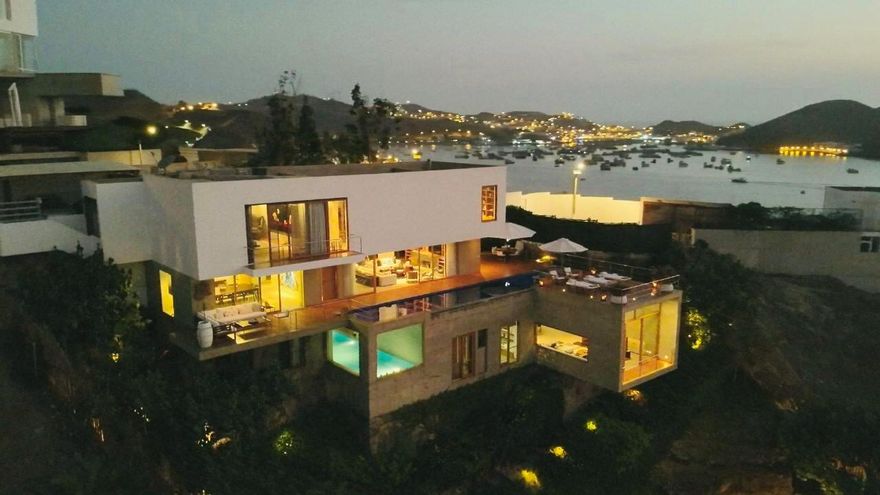 Behold the breathtaking beauty of this magnificent 4-level Luxury Ocean Front Home, nestled along the Pacific Ocean coast amidst lush green trees, gardens, and a serene pergola perfect for meditation. With two entrances through the yacht club streets, this one-of-a-kind property is a true masterpiece. Designed by the prestigious builder and architect David Mutal, this home is a piece of art. The property boasts 3 living rooms, a cozy fireplace, 2 dining rooms, 2 kitchens, 3 master bedrooms (suites), 2 guest bedrooms, walk-in closets, 8 bathrooms, 2 balcony terraces, an outdoor pool, a gym and spa with an heated indoor pool, steam & dry saunas, and a massage room. A loft office/studio, two maids quarters with a bathroom, 5-car garages and laundry room. Also includes a Guest/Guardians house,