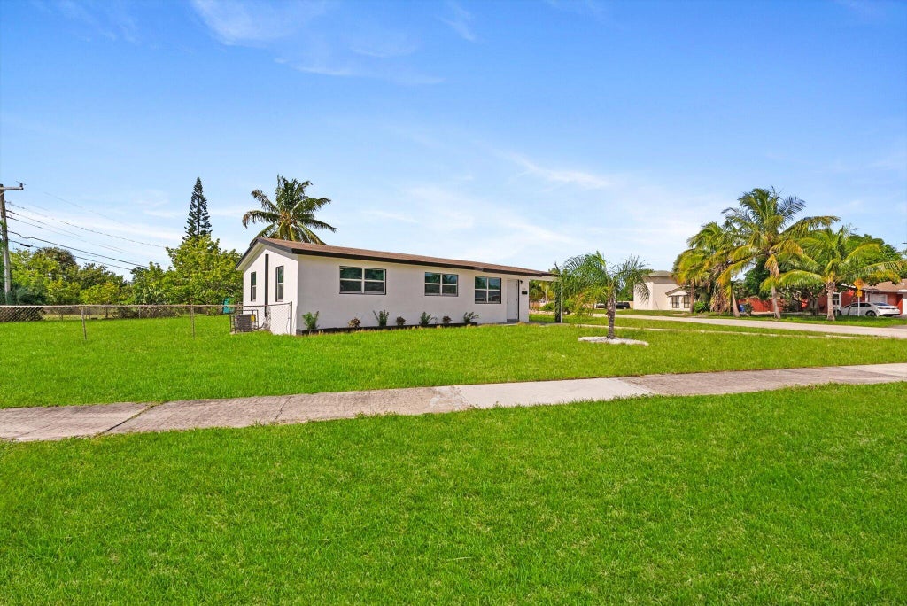 Photo of 1420 9th Street, Lake Park, FL 33403 (MLS # B26089576)