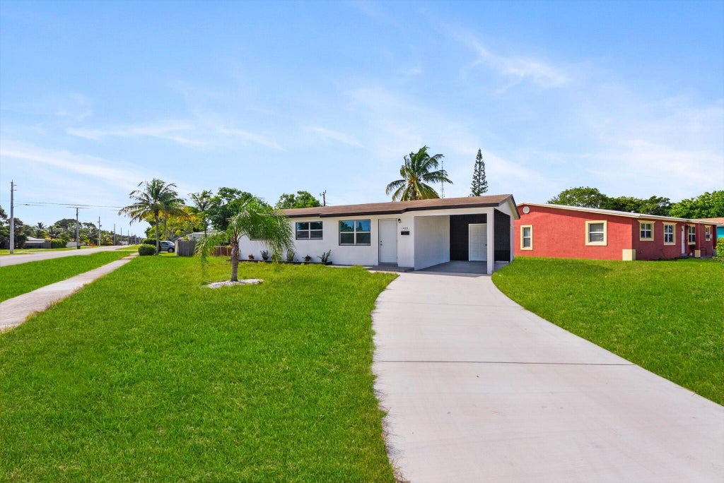 Photo of 1420 9th Street, Lake Park, FL 33403 (MLS # B26089576)