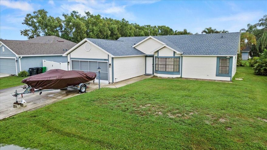 Discover this thoughtfully maintained 3-bedroom, 2-bath home in a peaceful Port St. Lucie neighborhood. It features a brand-new 2025 roof and a split floor plan with vaulted ceilings for an open, airy feel. The kitchen offers newer appliances, granite counters, a cozy breakfast nook, and a convenient coffee bar counter space.  Spacious living and dining areas suit both everyday comfort and entertaining. The primary suite includes a walk-in closet, dual-sink vanity, tub/shower combo, while two additional bedrooms provide space for guests or a home office. Step outside to a screened-in porch and private yard with space ready for a pool or garden. A widened driveway offers room for extra parking, a boat, or a trailer. No HOA.
