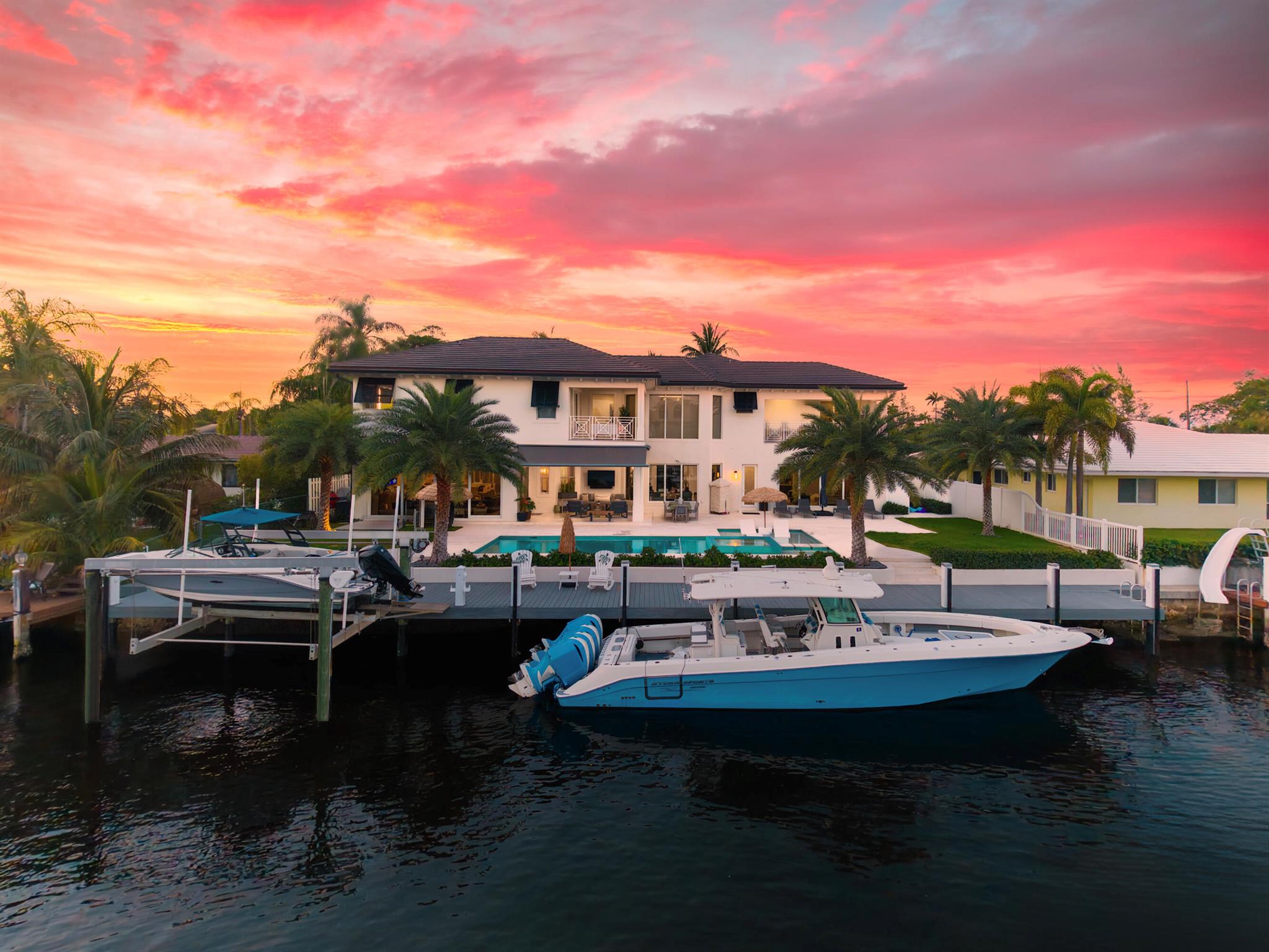Immaculate Custom Waterfront Estate Discover this remarkable custom waterfront residence tucked away on one of Pompano Beach's most secluded streets, bordered by the quiet green space of Exchange Park to the north. Thoughtfully crafted and impeccably cared for by its owners, this home is an ideal retreat for boating enthusiasts, car collectors, or anyone who appreciates generous living space and coastal tranquility. Set on 105 feet of deepwater frontage with direct ocean access and no fixed bridges, the property is just five minutes from the Hillsboro Inlet, offering an effortless gateway to open water. Inside, over 6,600 square feet of well-planned living space includes five comfortable bedrooms, each with its private bath, arranged in a split layout that balances togetherness