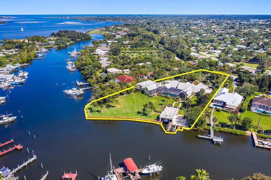 Find paradise here on two & a half beautifully landscaped acres on Willoughby Creek! This lovely, walled compound includes a sprawling 4 bedroom, 5 bath home with separate guest house & garages, & a truly spectacular boat house! The oversized swimming pool/spa lanai offers an unparalleled indoor/outdoor lifestyle with its spectacular summer kitchen & seating area! Simply too much here to pass up! If you want it all, located at one of Stuart's best addresses, don't miss this one! The separate RV garage will accommodate the largest motor coach with an attached single garage currently used as an art studio. House has a three car attached garage, also & a wonderful paved driveway offering tons of additional parking! Both formal & informal living and dining areas! Truly one-of-a-kind!