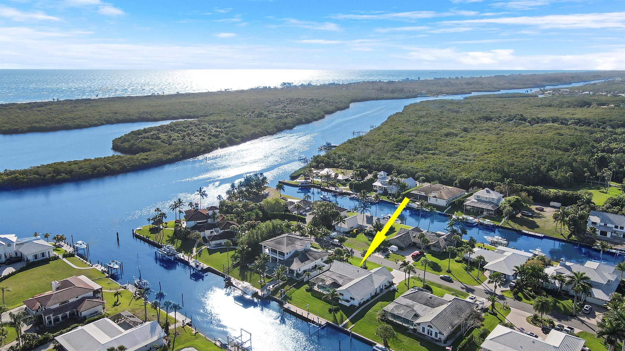 Stunning waterfront home with Florida charm blended with modern updates. This completely renovated 4 Bedroom 3 Bathroom retreat is located in a highly desirable Treasure Coast waterfront community, 3 homes from the end of a tranquil street off the intracoastal waterway. CBS construction with hurricane impact protection and attached 2 car garage. Enter into an exquisite grand living/family room with breath taking views of the pool and water. The heart of the homes features a chef's kitchen featuring Thermador 6 burner gas range, GE Cafe appliances. Custom white cabinetry, 9' walnut center island with quartzite countertops. Wood plank design tile flooring throughout the home. Waterfront features a 60'x8' composite deck with 16k lb boat lift on a 100ft wide canal. No fixed bridges.