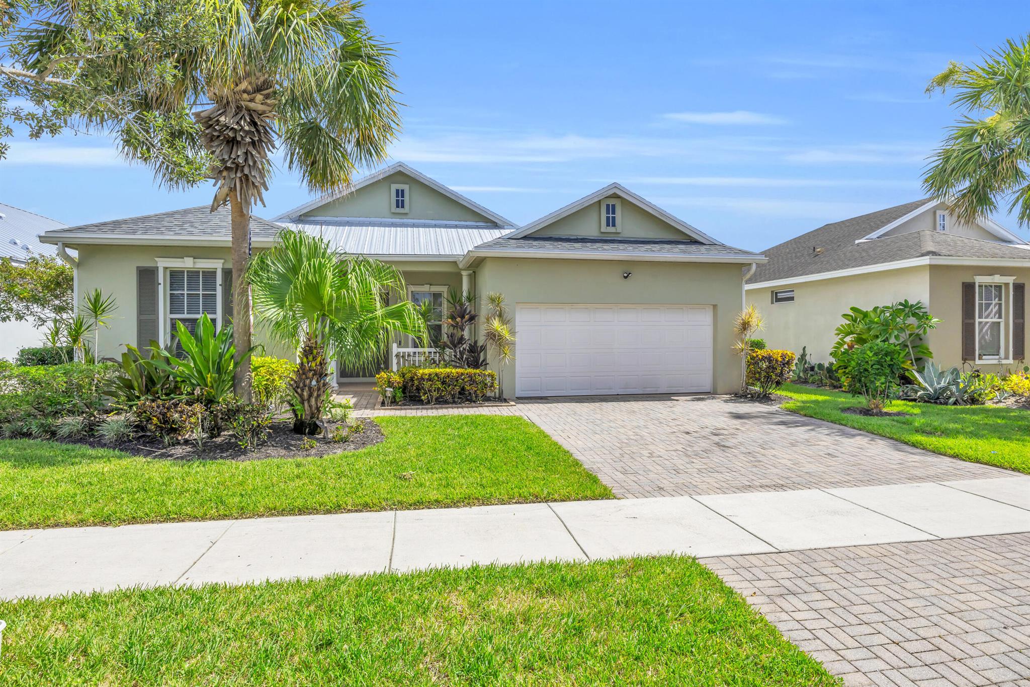 Prime location in Tradition! Walk out to parks, shopping and restaurants galore! This 3 bed/2 bath/2 car garage open concept floorplan feels extra spacious with its volume ceilings and 20'' tile set on the diagonal. The large backyard is fully fenced providing extra privacy. Community clubhouse & pool, butterfly & dog parks are within walking distance. HOA fee includes lawn care, basic cable, internet, sprinkler system and storm sewer assessment. Roof replaced in 2021. Newer appliances, AC & water heater. I-95 is close by as is the Tradition Town Center that hosts many events throughout the year. Come see why this home is ready to be yours!