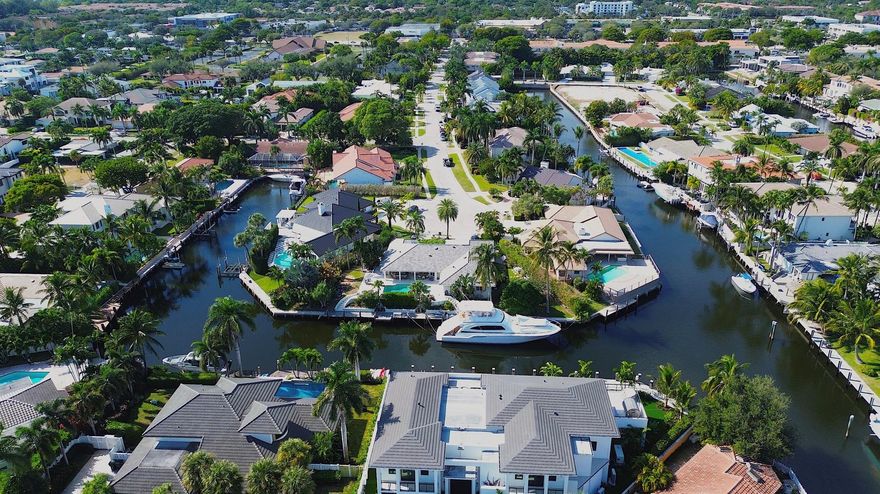 EXCEPTIONAL EAST BOCA RATON HOME WITH 180' OF STRAIGHT WATERFRONT WITH DEEP WATER ACCESS & NO FIXED BRIDGES! Perched at the end of a cul de sac peninsula, this coastal stunner is highlighted by a massive 100 foot dock (2015) capable of housing a fleet of boats! Complete impact windows & doors (2014), concrete tile roof (2014) & a massive 13,500 sq foot lot make this property a stunning South Florida value. Step into coastal breezes & island serenity perched above the water. Ideally located between downtown Boca Raton & Atlantic Avenue, Boca Bay Colony is quickly and quietly becoming a premier east Boca Raton boating destination. With newly-built custom estates, easy ocean access, massive lots, wide streets & buried power lines, see why this neighborhood is the secret no one knows about!