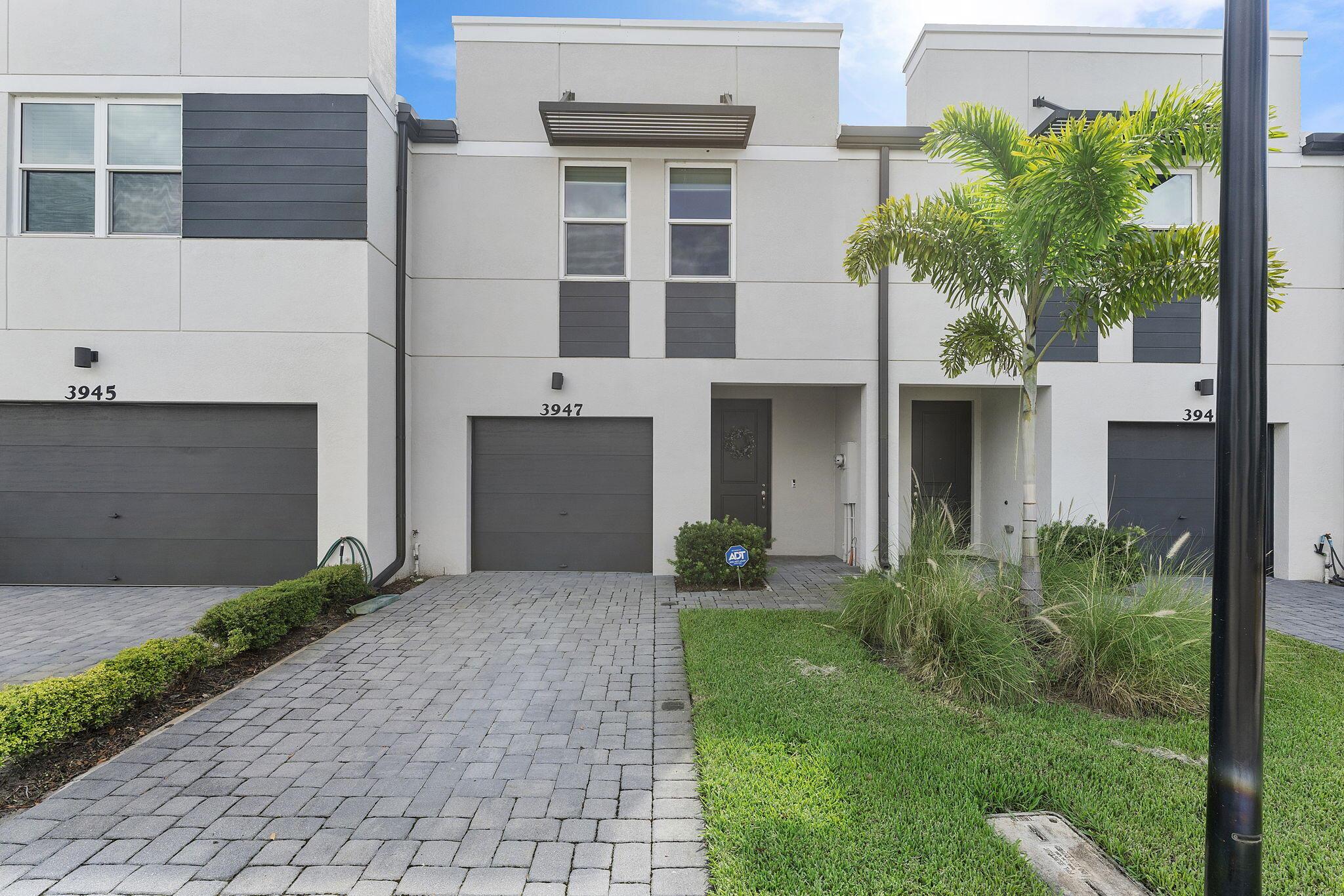 This stunning 3-bedroom, 2.5-bathroom townhouse offers a lakeview. Its contemporary design features bright, airy interiors filled with natural light, creating an instant feeling of spaciousness. The main living area includes elegant light-colored tile flooring and stylish fixtures such as modern ceiling fans and pendant lights, adding a sophisticated touch.