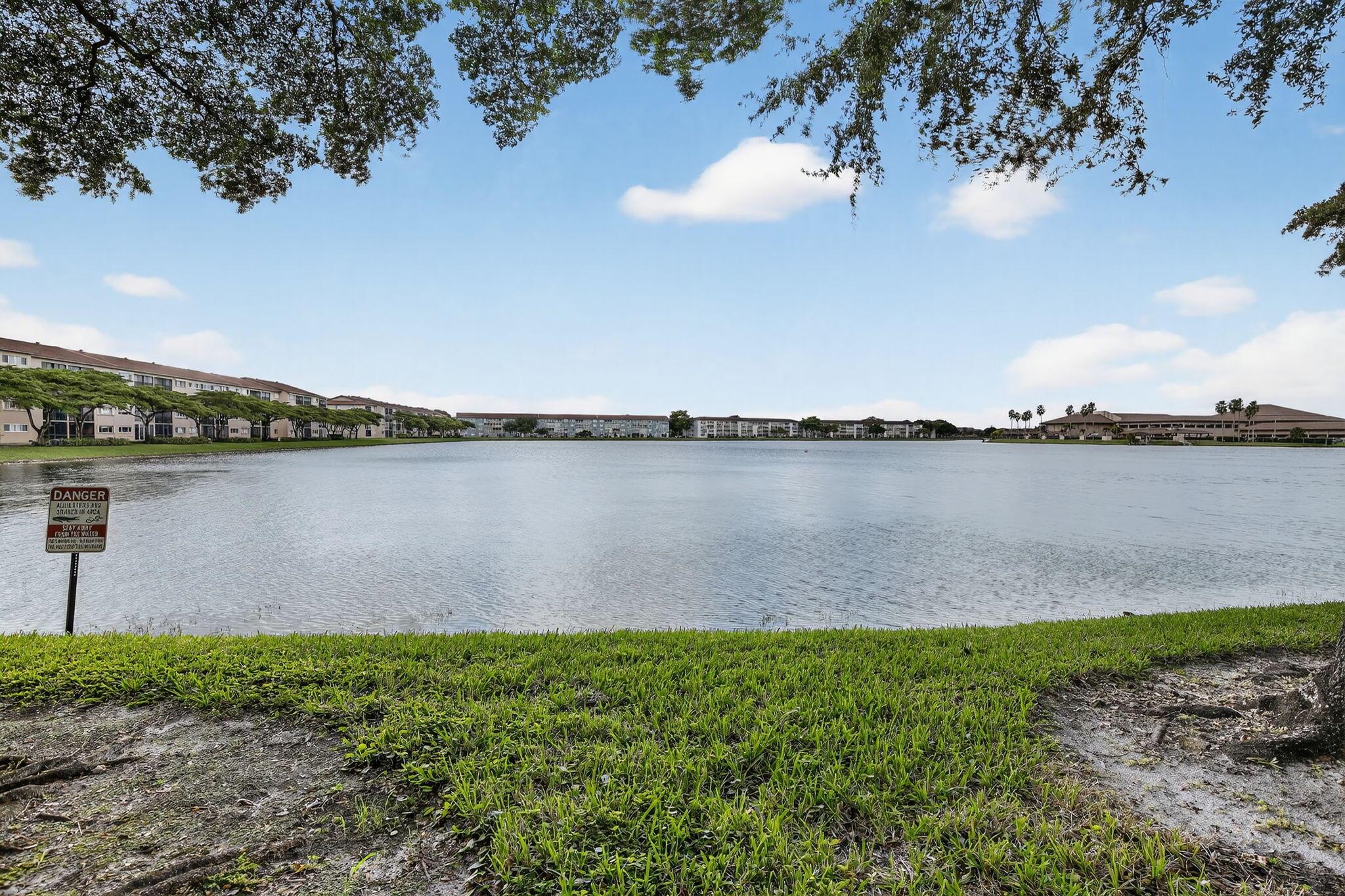 Step into this beautifully updated 2-bed, 2-bath condo in the sought-after 55+ community of Century Village Pembroke Pines. Enjoy an open, light-filled layout with wood-look tile flooring, a modern kitchen, and serene water views from your private screened patio. The primary suite offers a spacious walk-in closet and ensuite bath. Resort-style amenities include pools, fitness centers, golf, tennis, and a clubhouse with entertainment. Conveniently located near shopping, dining, and major highways--this home blends comfort, style, and South Florida living at its best.