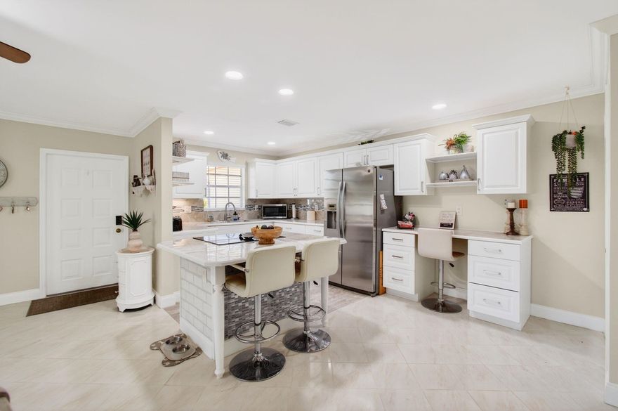 Pride of ownership is evident the moment you step into this highly sought-after, updated, bright and spacious 2BR/2BA corner villa -- the desirable Florida Model - nestled in a vibrant 55+ community. This beautifully maintained home features a new roof (2019), water heater (2019), and AC handler (05/2023) for added peace of mind. The leveled flooring flows throughout with neutral tile and laminate finishes, smooth ceilings (no popcorn), and elegant crown molding. The remodeled open-concept kitchen is a true highlight, showcasing:
Updated cabinetry. Marble tile countertops, Decorative backsplash with under-mount lighting, Modern appliances, High-hat lighting, Large custom pantry, Built-in desk area.
Enjoy added living space in the enclosed Florida room under air, complete with French door for privacy. Additional features include awning shutters and a stacked full-size washer and dryer conveniently located inside the primary closet. Both the guest and primary bathrooms have been tastefully updated. The villa is offered turnkey, with upgraded furnishings--just bring your clothes and toothbrush!
Experience Florida living at its finest in this active 55+ community offering: Large heated resort-style pool, Expansive clubhouse, 
Tennis & pickleball courts, Shuffleboard, Numerous planned social activities, ideally located just minutes from the beach, shopping, dining, theaters, major highways (I-95 & Turnpike), and places of worship.
**All information is deemed reliable but not guaranteed and subject to change without notice.**