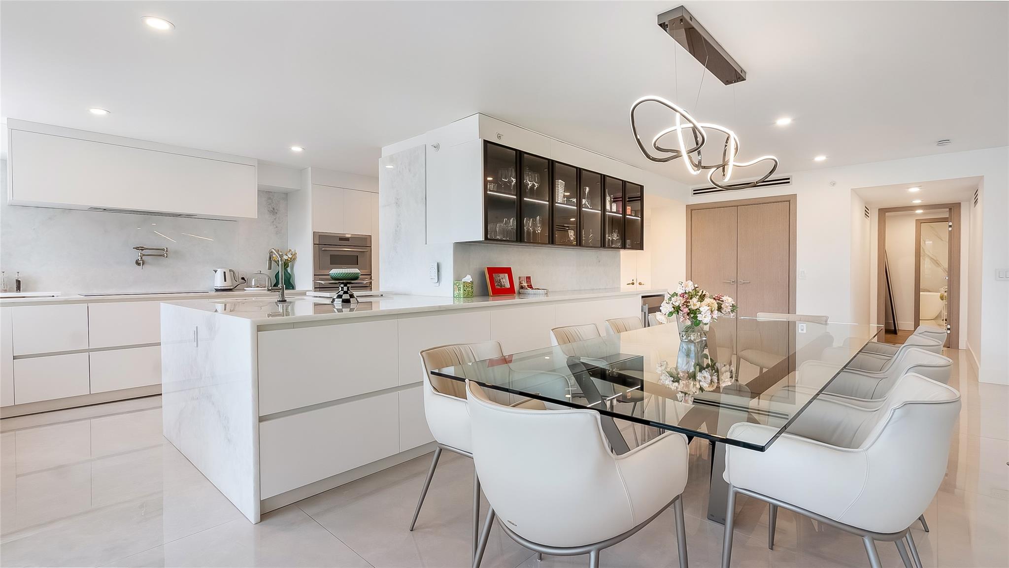 Step into refined elegance with this fully renovated waterfront condo offering sweeping views of Lake Boca. Every detail of this 2,430 sq. ft. residence was meticulously crafted using premium materials imported from Italy. Highlights include 48-inch porcelain tiles, white oak chevron floors, marble countertops, and a custom kitchen with Thermador appliances and a hidden coffee station. All doors, trim, fixtures, and built-ins are custom-designed, with impact glass and motorized blackout shades throughout. The Carlton features a newly updated lobby, 24-hour doorman, fitness center, pool, and Pickleball & Tennis Courts are Coming Soon as well as a dockside BBQ and Outdoor Kitchen! This is a prime location just steps from the beach and the World Famous Boca Raton Resort & Golf Club.
