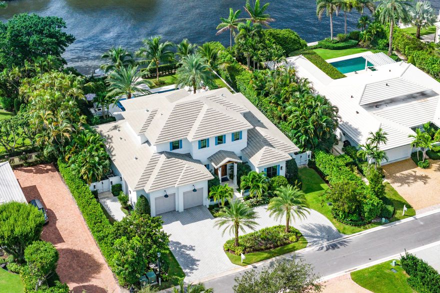 Perfectly positioned in the heart of Gulf Stream, this exceptional residence, designed by renowned architect Richard Jones and recently completed by Marc Julien Homes, sits on a deep, beautifully proportioned lot along a wide deep-water canal, just moments from the beach and the Gulf Stream School. Encompassing 5,103± total square feet, this masterfully designed estate offers six bedrooms and six-and-one-half baths. Defined by timeless coastal living and light-filled interiors, the home features a gracious great room with gas fireplace and wet bar, and floor-to-ceiling glass doors that open to panoramic water views creating a seamless connection between indoor and outdoor living. The main level also includes a tranquil primary suite with spa-inspired bath and custom closets, a private office/bedroom with full bath, and a flexible guest suite. At the heart of the home, the kitchen is both beautiful and functional, with bespoke cabinetry from floor to ceiling, a custom island, quartz countertops, and a fully equipped pantry with commercial grade refrigeration. The large custom breakfast nook serves as an inviting gathering space overlooking the water. Upstairs, three additional guest suites and a versatile loft offer privacy and comfort for family and friends. Outdoors, a spacious loggia with summer kitchen, saltwater pool and spa, fire pit, and a private dock with boat lift are perfectly oriented to capture serene canal views. Additional highlights include a whole-house generator and two-car + golf cart garage. 530 Old School Road embodies the best of Gulf Stream livingarchitectural integrity, deep-water access, and an enviable location close to sandy beaches, fine dining, and the boutique charm of Delray's Atlantic Avenue. Your favorite part of going out will be coming home.