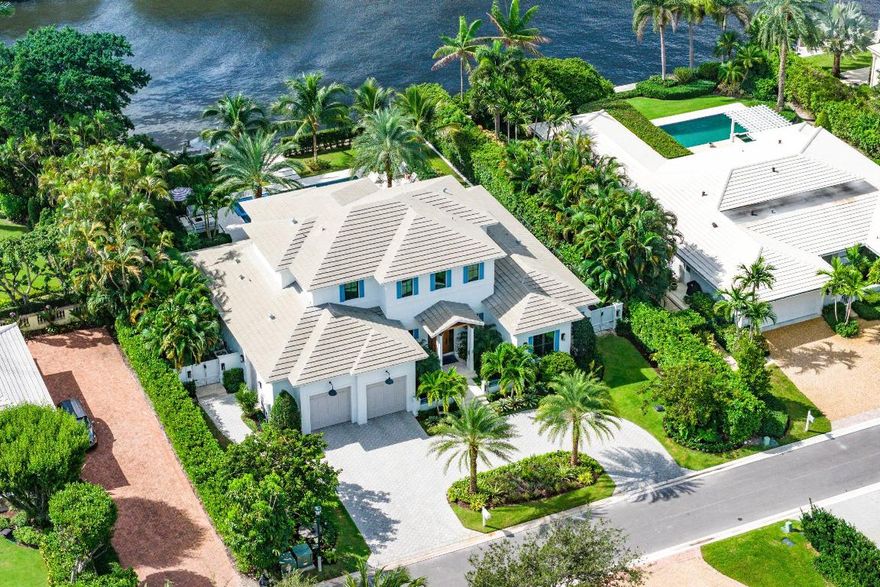Perfectly positioned in the heart of Gulf Stream, this exceptional residence, designed by renowned architect Richard Jones and recently completed by Marc Julien Homes, sits on a deep, beautifully proportioned lot along a wide deep-water canal, just moments from the beach and the Gulf Stream School. Encompassing 5,103± total square feet, this masterfully designed estate offers six bedrooms and six-and-one-half baths. Defined by timeless coastal living and light-filled interiors, the home features a gracious great room with gas fireplace and wet bar, and floor-to-ceiling glass doors that open to panoramic water views creating a seamless connection between indoor and outdoor living. The main level also includes a tranquil primary suite with spa-inspired bath and custom closets, a private office/bedroom with full bath, and a flexible guest suite. At the heart of the home, the kitchen is both beautiful and functional, with bespoke cabinetry from floor to ceiling, a custom island, quartz countertops, and a fully equipped pantry with commercial grade refrigeration. The large custom breakfast nook serves as an inviting gathering space overlooking the water. Upstairs, three additional guest suites and a versatile loft offer privacy and comfort for family and friends. Outdoors, a spacious loggia with summer kitchen, saltwater pool and spa, fire pit, and a private dock with boat lift are perfectly oriented to capture serene canal views. Additional highlights include a whole-house generator and two-car + golf cart garage. 530 Old School Road embodies the best of Gulf Stream livingarchitectural integrity, deep-water access, and an enviable location close to sandy beaches, fine dining, and the boutique charm of Delray's Atlantic Avenue. Your favorite part of going out will be coming home.