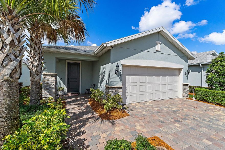 Located in the desirable community of Heron Preserve in Tradition, this inviting 3 bedroom, 2 bath home with a 2 car garage offers comfort, style and convenience. The open floor plan is perfect for both everyday living and entertaining, with seamless flow between the living, dining and kitchen areas. Impact windows provide added peace of mind and natural light throughout. The kitchen features quartz countertops, white shaker soft-close cabinets and stainless steel appliances. Conveniently located near shopping, dining, parks and all that Tradition has to offer while tucked away in a peaceful community setting.
