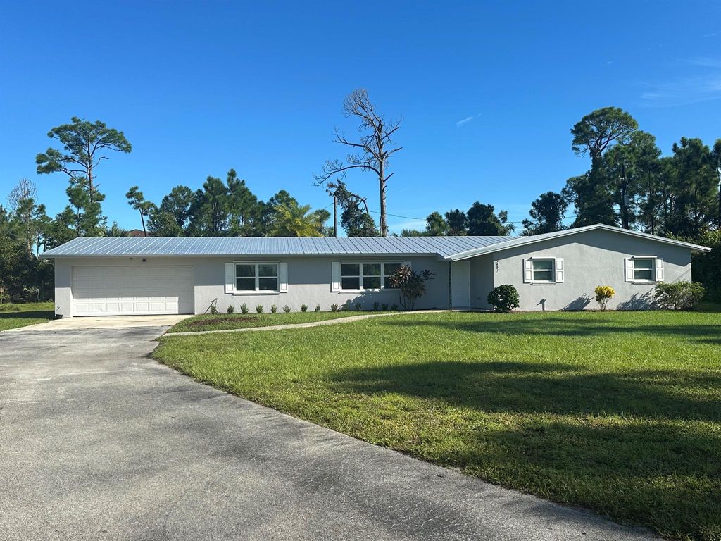 Photo of 5407 Turnpike Feeder Road, Fort Pierce, FL 34951 (MLS # R11125867)