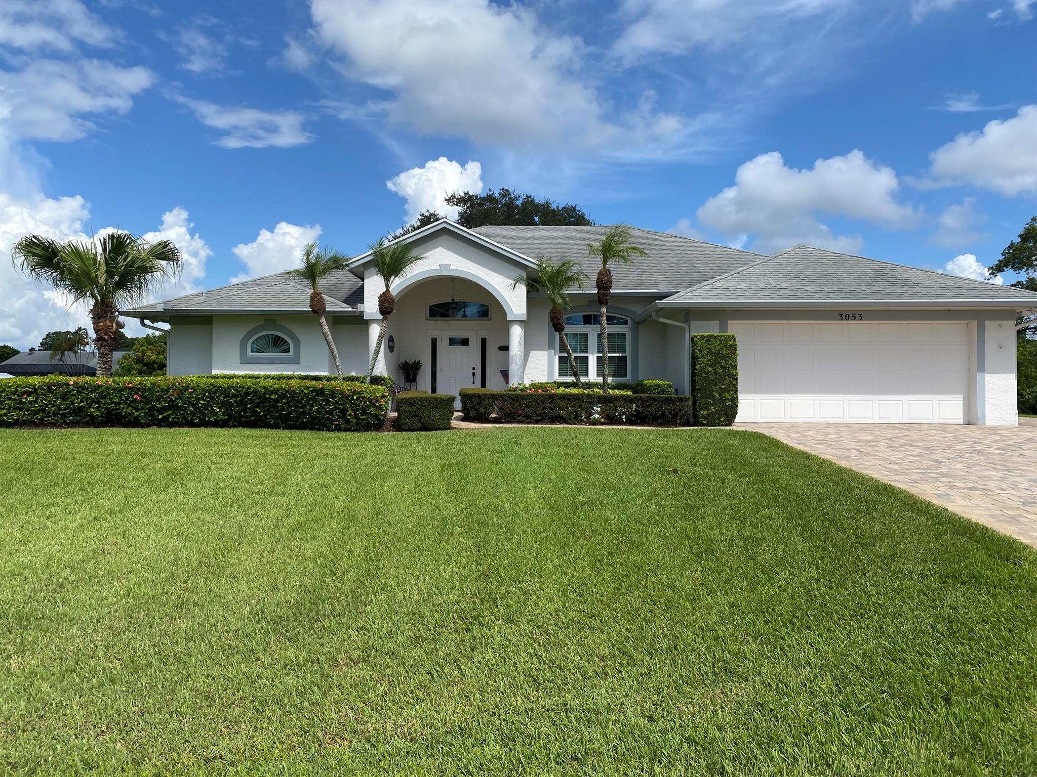 Beautiful well maintain home in the desirable Sandpiper Bay Community. Home is on an oversized 1/2 acre lot with a view of a creek for privacy. 4 bedroom 2 bath home built by Tropical homes with one owner since 1996. Gorgeous upgraded kitchen with granite counter tops, undermount sink and tile backsplash, Upgraded cabinets, Hardwood floors in the family room, Kitchen, Dining Room, Hallway and Foyer. Garage has a 3 foot extension in depth, Paver driveway and patio with parking for RV or Boat with 220 electric available. Central vacuum, speaker system in the family room and porch. Carpet in all bedrooms. Impact windows throughout. Roof replaced 2012, A/C 2020. 2 Mango Trees and 3 Avocado trees. Auto Sprinkler with new pump and on well water. ADT Security.