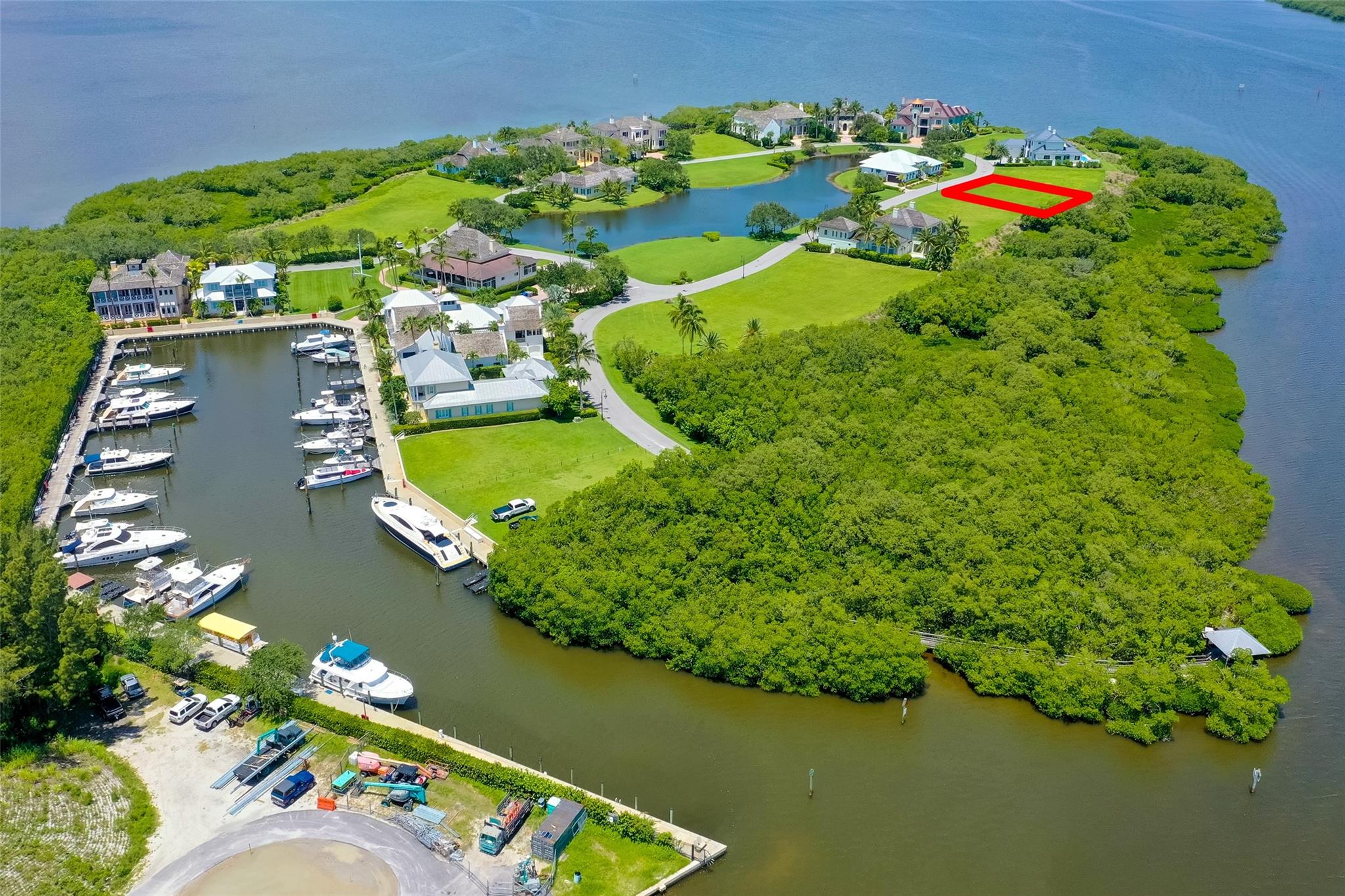 Amazing lot backing to the mangroves and the Indian River Lagoon + 65 foot DOCK/slip in neighborhood marina for 55 foot yacht! Ideal site for your legacy property within the waterfront enclave of Marsh Island. 102' of long eastern riverfront views! Community has a stately clubhouse, safe harbor and dock master. Minutes to beaches, Disney resort, Grand Harbor Golf & Beach Club plus shops/services + more.