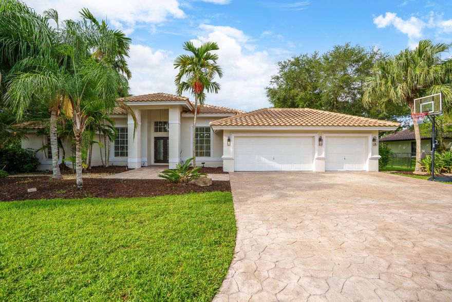 Nestled in a charming and quaint community of just 39 homes, this one-story home is just perfection. The roof was replaced in 2023, and in 2024, hurricane impact windows and doors were elegantly installed, ensuring both safety and style. Freshly painted inside and out, the residence boasts an impressive layout featuring six 
bedrooms, three bathrooms, and a three-car garage . Enjoy versatile living with a den that can easily serve as a theater, game room, or gym. Step outside to your own serene oasis, complete with a sparkling pool and a sprawling yard that leads directly to the water. The interior showcases tile flooring in the social areas for easy maintenance, while the bedrooms feature rich wood floors. The kitchen is equipped with stainless steel appliances, ideal for the home chef.