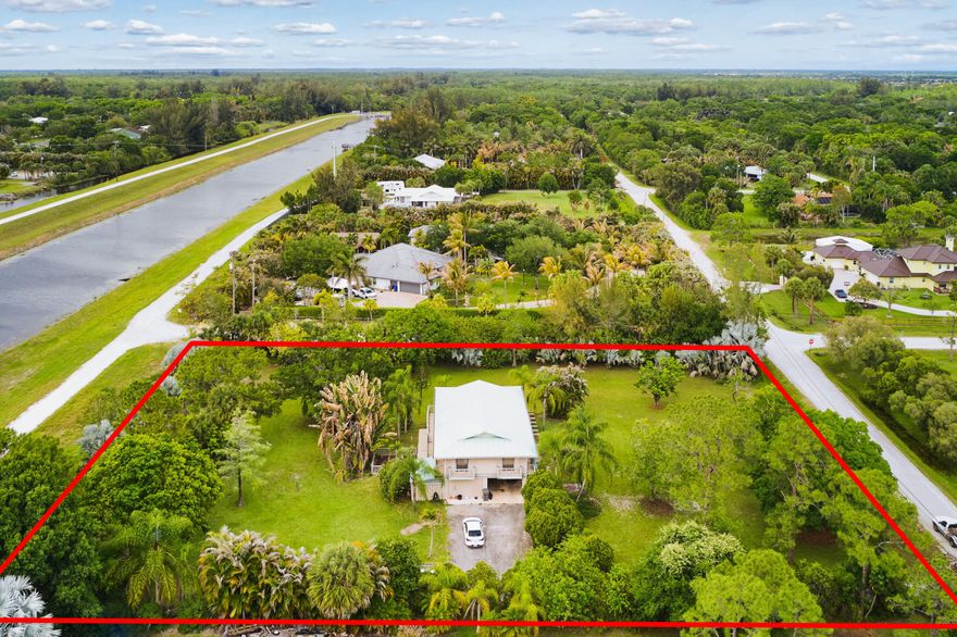 An extraordinary offering of 1.8 acres set along the tranquil C-18 canal connected to Jupiter public water. This expansive homesite presents a rare opportunity to build a bespoke estate in a serene natural setting with sweeping grounds and incredible privacy. Whether you envision a modern waterfront showpiece or a timeless estate, this property is a blank canvas with exceptional upside.