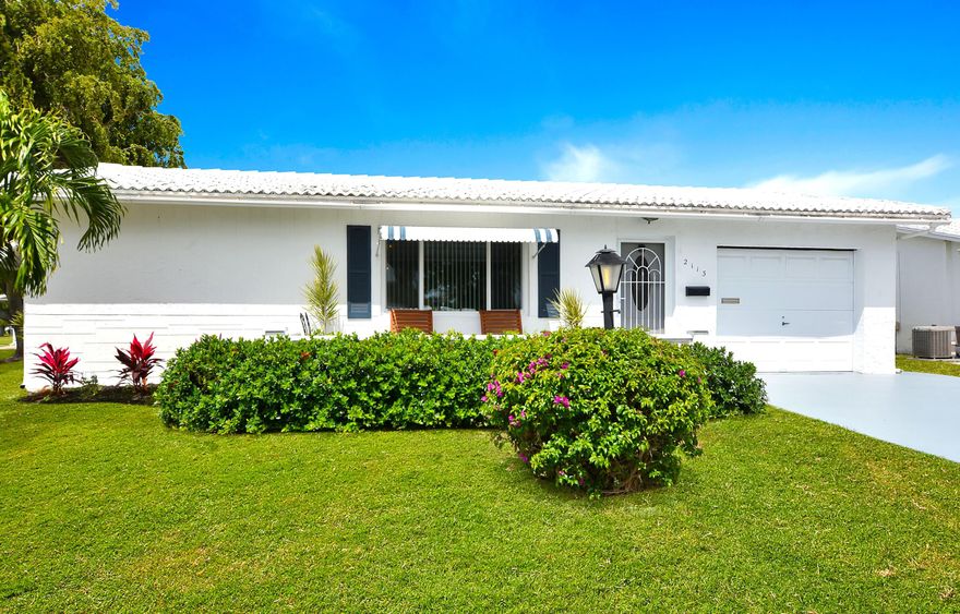 Stunning expanded corner Challenger 2BR/2BA split bedroom layout.  Oversized east-facing front porch welcomes cooling Gulfstream breezes.  Kitchen updated with newer cabinetry, tiled countertops and backsplash.  Bright Florida room with sliding glass doors out to screened in porch.  Impact front window.  Textured knockdown ceilings.  Neutral tile throughout. Double concrete drive. A/C 2020. Hot water heater 2018.   Enjoy an active clubhouse lifestyle with heated pool, jacuzzi, complimentary 9-hole pitch & putt golf, updated fitness center, shuffleboard and Bocce.  Furnishings available separately.  Just minutes to beautiful ocean beaches - relax, stay active and enjoy the Florida lifestyle.  A Must see.  Available for quick close.