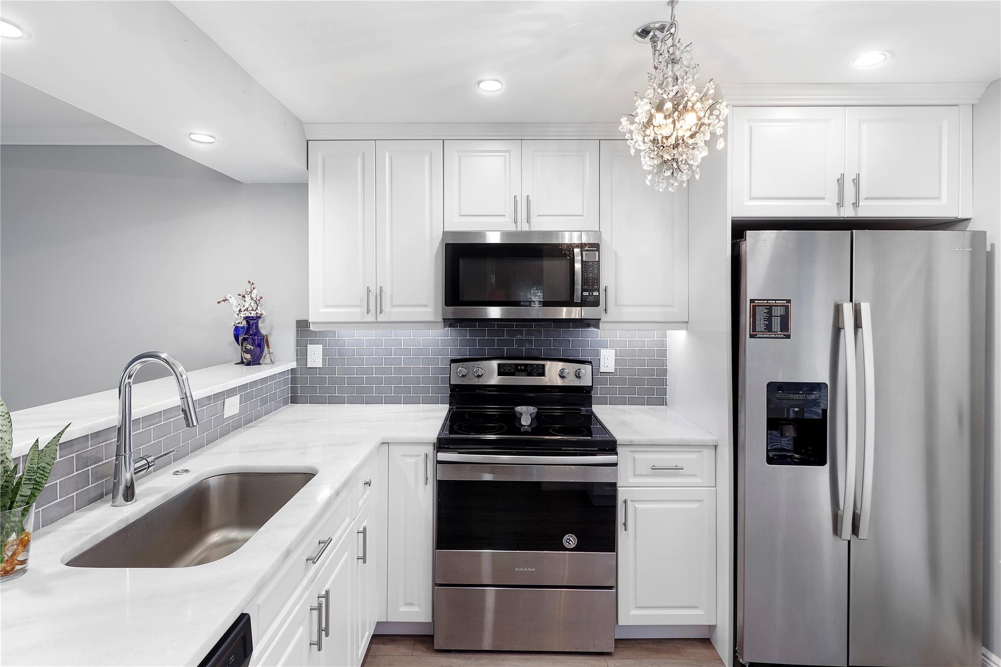3 BEDROOMS and completely renovated!! This condo boasts a new kitchen with marble countertops, sleek white cabinetry, a gray glass tile backsplash, and stainless steel appliances. The stunning bathrooms showcase chic hardware and quartz countertops. Say goodbye to carpets – the entire condo has wood and ceramic flooring. Located in Wynmoor, a premier adult community designed for an active lifestyle, it offers guard-manned gated entrances, resort-style heated pools, a fitness center, golf, tennis courts, game rooms, workshops, a movie theater, and a restaurant. This condo is just 6 miles from beautiful beaches and is conveniently situated off the Florida Turnpike. Wynmoor's meticulously maintained and professionally landscaped grounds, create a Florida paradise you'll love calling home.
