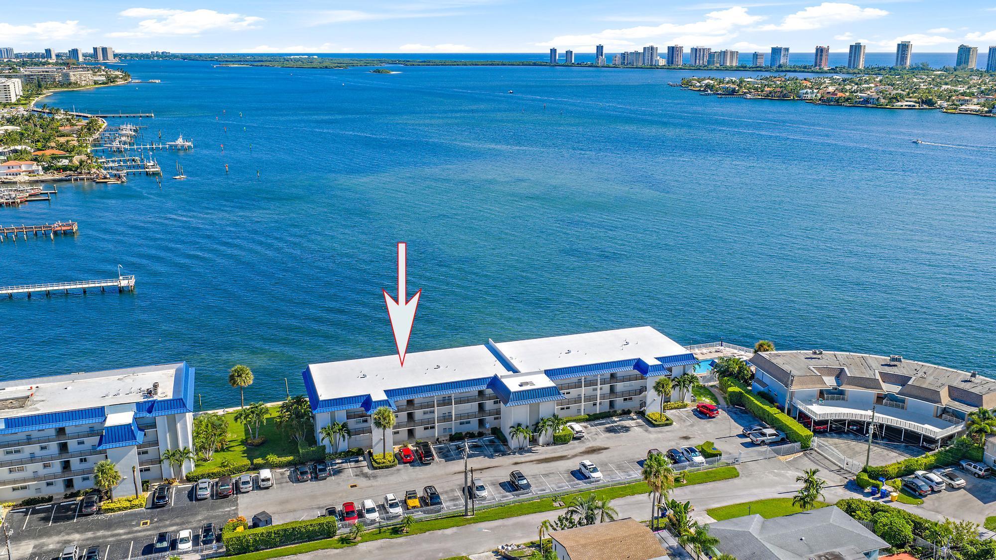 Waterfront Living at Its Finest! Enjoy everlasting Intracoastal views from this 1st-floor condo. Featuring tile and laminate flooring, a freshly painted interior, and an enclosed patio that adds extra living space, this home is the perfect retreat.Relax by the resort-style Intracoastal pool, with peace of mind thanks to a brand-new roof (2025) and convenient parking right outside your door. Just a short stroll to Publix, dining, shopping, Singer Island's beaches, and PBI Airport, this condo offers the ideal mix of relaxation and accessibility. Perfect as a full-time residence, vacation getaway, or investment. Don't miss your chance to own a piece of paradise with unmatched water views--schedule your showing today!