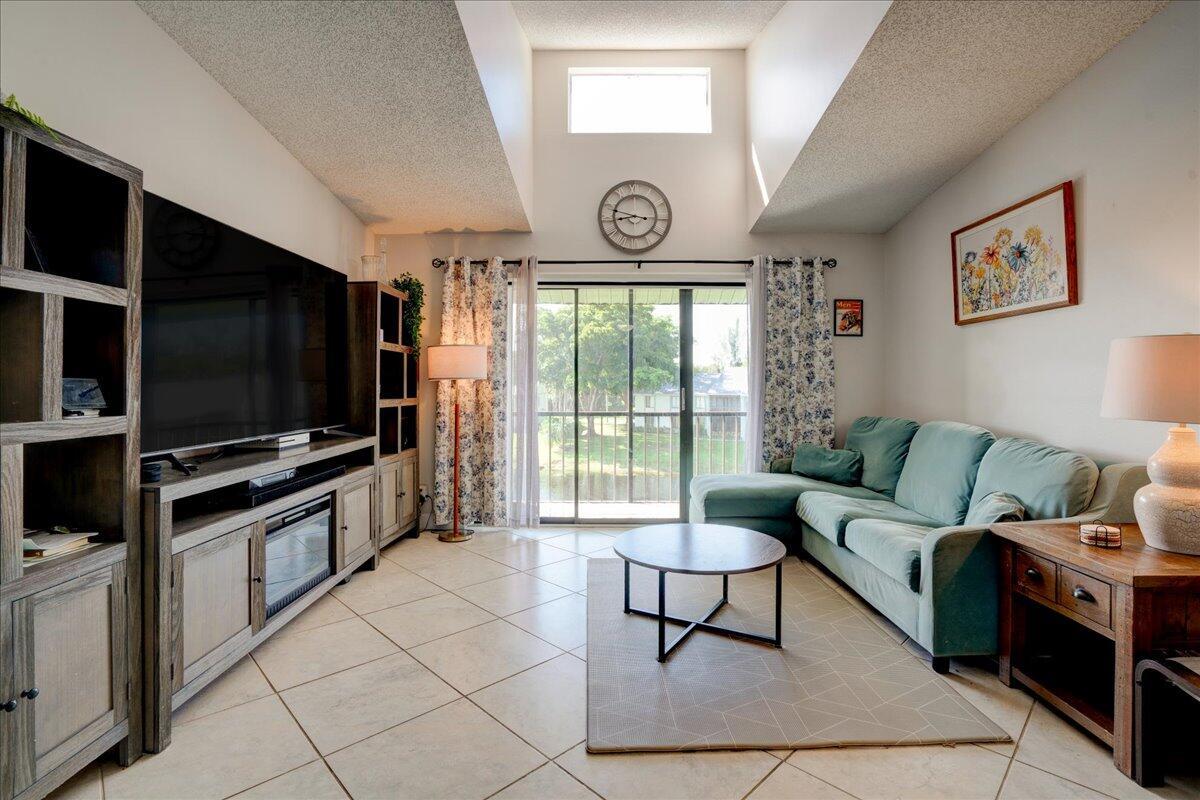 Lovely 2 bed/2 bath condo, located on the 3rd floor with vaulted ceiling, lots of natural bright lighting, tile throughout, and stunning views of the serene lake with fountain in an all age community. AC 2023, Kitchen Appliances 2022, Water Heater 2019, roof 2023. This gated community has a fenced in pool, clubhouse, tennis/pickle ball court, and tons of guest parking. (1) assigned parking space and guest spaces available. No Lease first 2 years. Great central location close to I95, turnpike, outlet mall, downtown, and the beach. Monthly HOA fee includes basic cable, internet, and water.