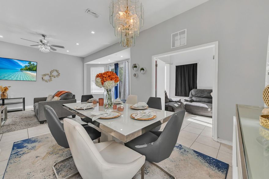 **Assumable Mortgage**
Welcome to this two-story home in the sought-after Foxhall community of West Palm Beach, with 3 bedrooms and 3.1 bathrooms.. The residence makes a dramatic first impression with its two-story foyer and a chic, open-concept main floor defined by polished tile flooring and contemporary gray walls. The spacious living and dining areas are illuminated by recessed lighting and a stylish chandelier, providing the perfect setting for entertaining. The kitchen offers a warm, inviting contrast with its rich, dark wood cabinetry, center island, and granite countertops, seamlessly blending traditional warmth with modern convenience. The luxury continues into the private quarters, where the Master Suite is a spa-like sanctuary that rivals any custom build. It features a spectacular free-standing soaking tub set into a bay window and a pristine, glass-enclosed walk-in shower with modern tile work. The suite is completed by a contemporary vanity with dual vessel sinks, epitomizing high-end design. Furthermore, the first floor includes a versatile bonus room/den with its own private access, and the attached garage hosts a dedicated laundry area with side-by-side washer and dryer units, ensuring exceptional daily convenience.

The upstairs bedrooms are generously sized and feature wood-look laminate flooring, offering comfortable and flexible spaces for family or guests. Step outside to a large, private backyard that is fully fenced, providing a fantastic blank canvas for a future pool, custom patio, or play area. This home expertly combines a striking, fully modernized interior with the desirable freedom of a private outdoor space, all situated in the highly coveted Foxhall communitya rare and exceptional opportunity in West Palm Beach.