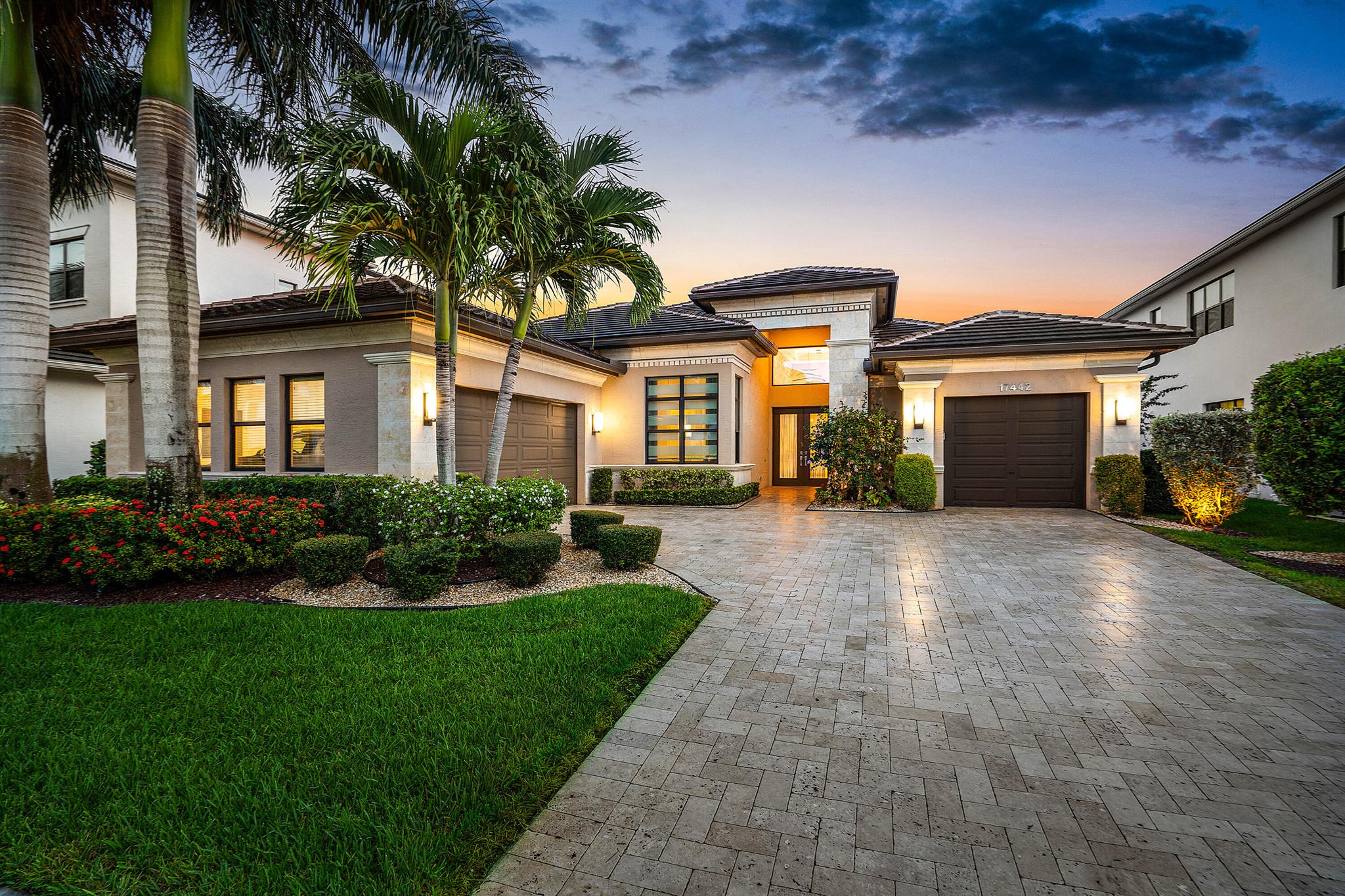 Welcome to 17442 Rosella Rd -- an exceptional Murano Model from the Coastal Collection, now being offered for the first time in the prestigious Boca Bridges. This expansive one-story home spans 3,792 square feet under air and showcases designer upgrades far beyond builder finishes.Perfectly positioned on a quiet cul-de-sac with coveted southern exposure, the home is light, bright, and thoughtfully appointed throughout. Soaring ceilings with detailed coffered designs add architectural elegance, while custom landscape lighting brings the property to life after sunset.At the heart of the home is a stunning custom kitchen featuring Sub-Zero appliances, double wall ovens, and an oversized island overlooking the main living room and dining/club room -- all designed for seamless indoor-