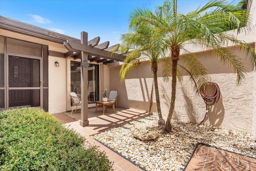 An immaculately maintained, spacious 2 BED/2 BATH one story VILLA. A peaceful retreat with a private courtyard entry, and large enclosed patio with lake and golf course views. This amazing home offers many upgrades including primary BR bay window views, two expansive walk-in closets, ample add'l storage, hardwood floors, vaulted ceilings, an in-home laundry room with washer and dryer, and accordion hurricane shutters. Rarely seen NON-MEMBERSHIP country club with extremely low priced golf and tennis options. 24/7 manned gate, 2 pools, 18-hole executive golf course, tennis, pickleball, pro shop, fitness center, restaurant, and entertainment clubs. GREAT LOCATION close to downtown Delray's world-class dining, beaches and shopping. A 55+ playground with something for everyone.