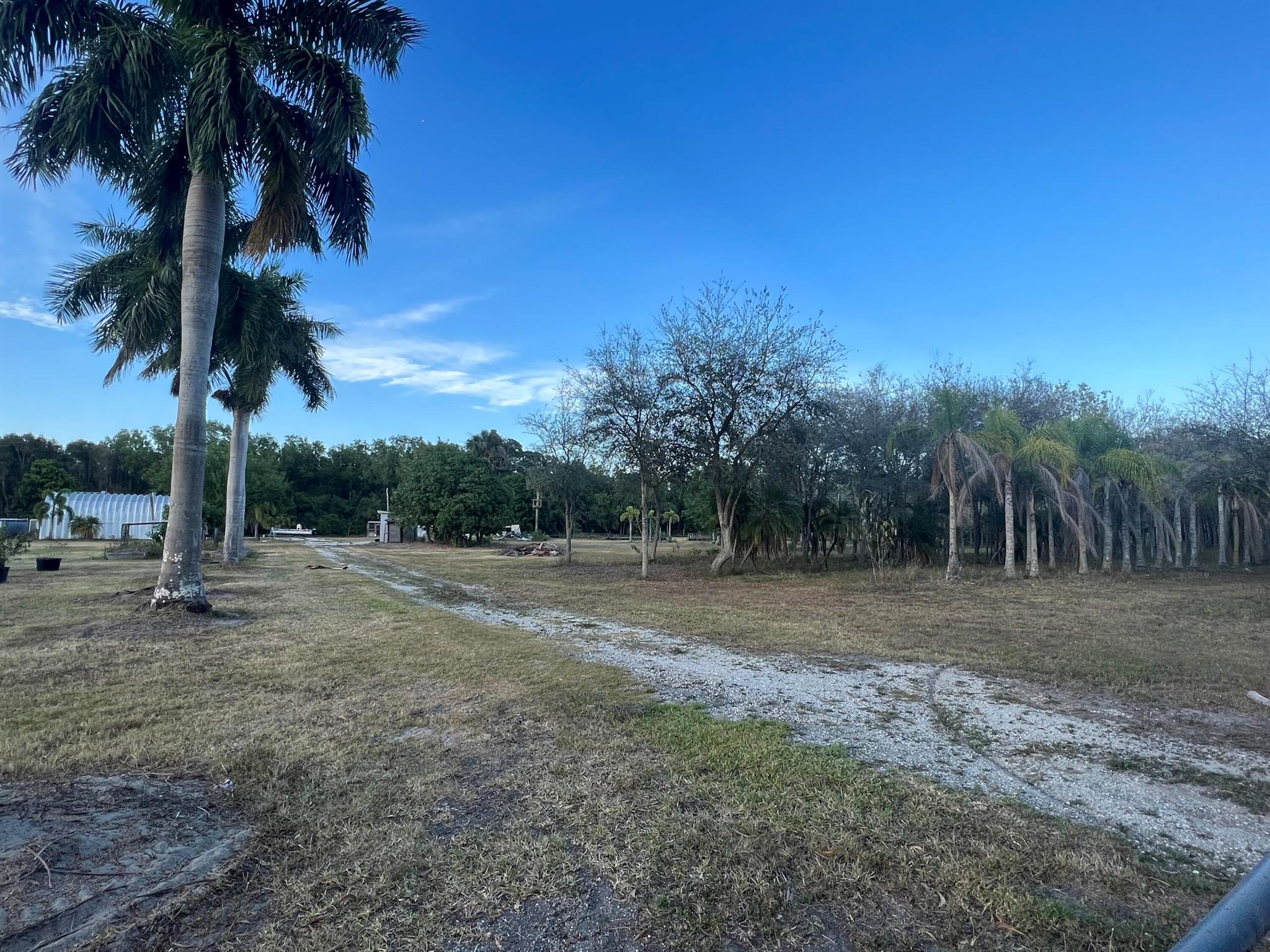 Amazing opportunity to buy a large piece of property at an amazing price!!! 7.28 acres. Property has electric and plumbing. Two bathrooms are located in a standalone building. Large enclosed metal building has two stories. No HOA - Bring your RV, boat, quads, dirt bikes, side-by-side, etc. Property is fully fenced. Possible seller financing with min. 20% down.