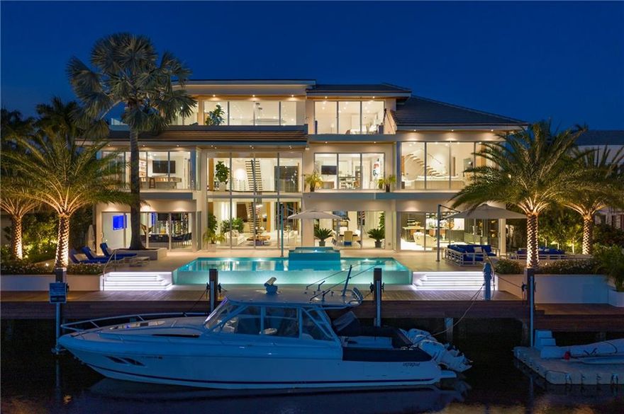 Custom ultra-modern 3 story masterpiece w/100' of WF on a wide canal. Just minutes to the inlet w/ Intracoastal views from 2nd & 3rd levels! Gourmet kitchen with top-of-the-line appliances. High-end finishes & features throughout - Ralph Lauren fixtures, custom woodwork, wine room, whole house generator, gym, elevator, theater, smart home security & automation systems. 3rd-floor entertainment space w/ wet bar & breathtaking views of the Intracoastal & downtown Fort Lauderdale. Immense master suite w/ sitting area, fireplace, water views & over-sized luxurious master bathroom. Private Harbor Beach Surf Club with 300 ft of beachfront & private marina membership available.