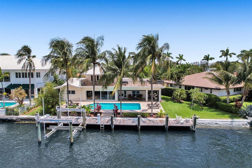 Beautifully reimagined 4 bedroom, waterfront home in the sought after Cove neighborhood. As the second lot on the canal, this home impresses with sweeping intracoastal views, a southern backyard exposure, 110 feet on the water and a large dock with boat lift. The backyard is perfect for entertaining with a covered patio complete with electric shades and a large pool. The property has impact glass throughout, a private and spacious master suite on the second floor, with a large bathroom and walk-in closet, vaulted ceilings and a stunning outdoor terrace to enjoy your morning coffee. Downstairs the home has a split floorplan with 3 bedrooms and 2 more baths. The kitchen features stainless steel appliances and beautiful granite counters. Just minutes to the beach, shopping and restaurants.